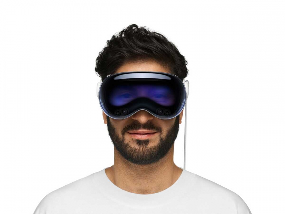 A man wearing the Apple Vision Pro. Apples EyeSight feature uses cameras and screens to display the users eyes to people around them.