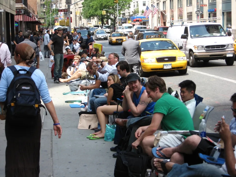 Customers wait outside the Apple Store to purchase the original Apple iPhone