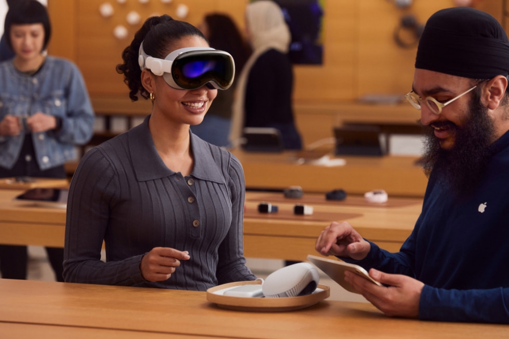 A woman uses Apple Vision Pro in an Apple Store.