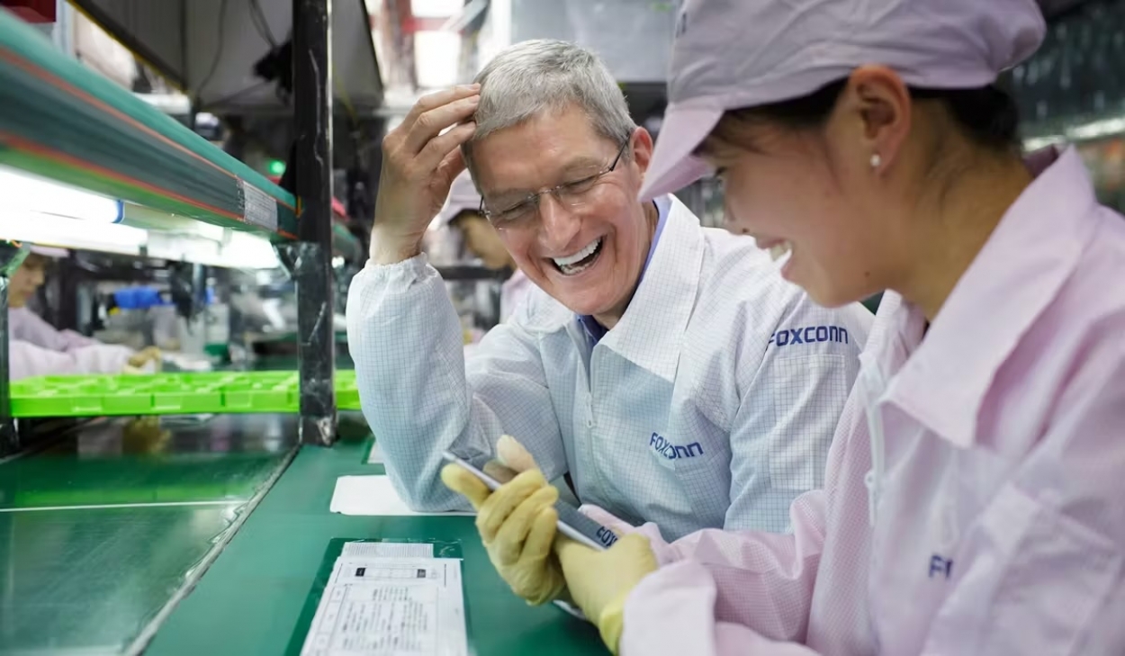 Current Apple CEO Tim Cook speaks with a lineworker at one of their Foxconn iPhone manufacturing plants in China.