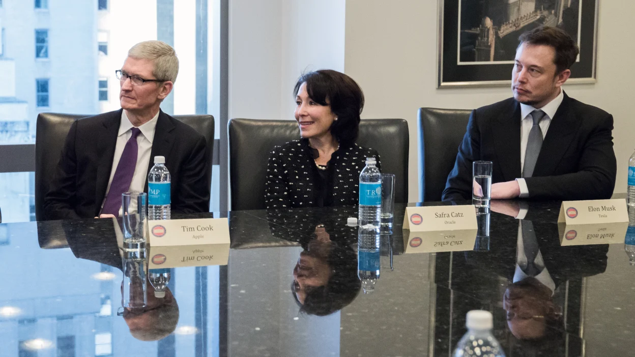 Tim Cook and Elon Musk listen in during a meeting together.