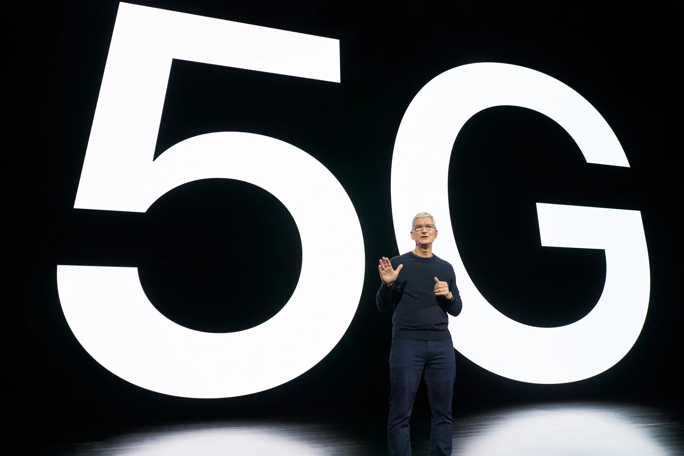 Tim Cook onstage annoucing the inclusion of 5G connectivity for the first time on iPhone.