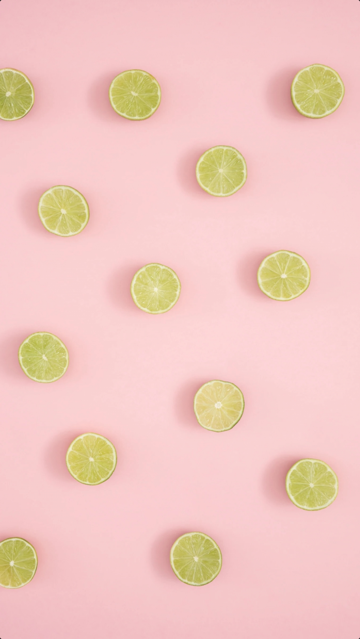 Lime Slices On A Baby Pink Background