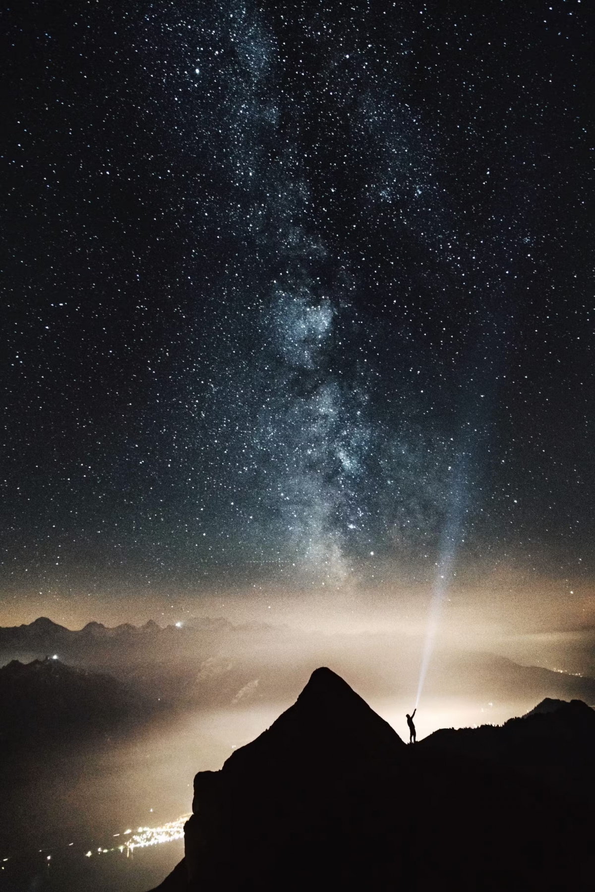 Guy Pointing A Torch Into Space With Stars