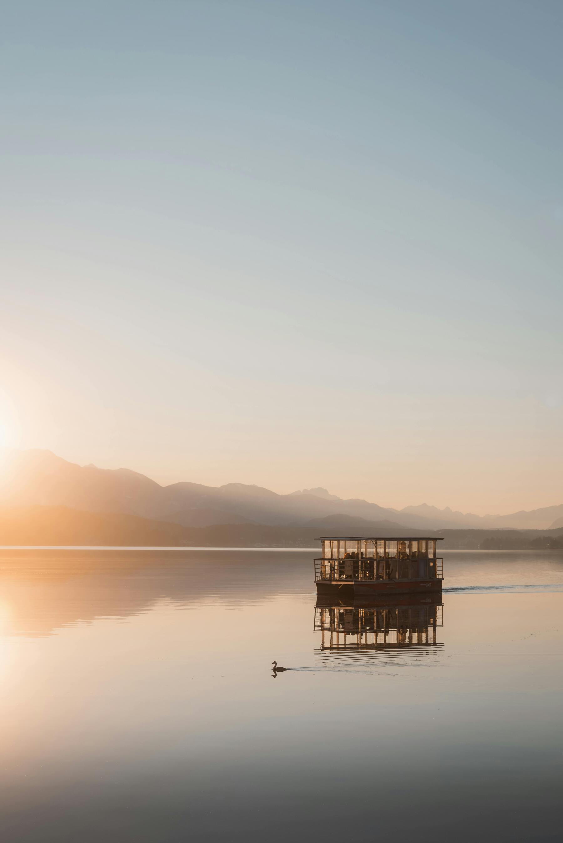 A Boat Goes Peacefully Over Serene Still Water Lake With Mountains In The Distance And Duck UltraHD Ultra HD 4K 8K 10K 12k 20k High Resolution HDR Highres Desktop Wallpapers For iPhone And Android