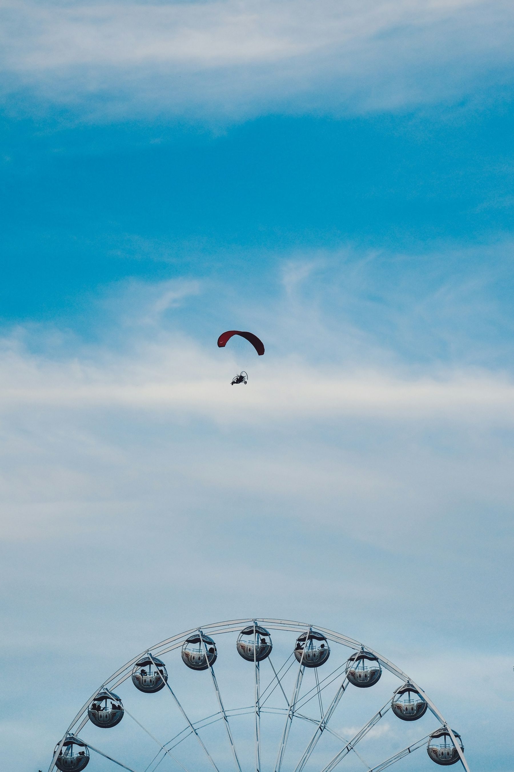 A Man In A Parachute Flies Over A Ferris Wheel Observation Wheel wallpaper for Apple iPhone, Apple Watch, Mac, iPad and Apple Watch