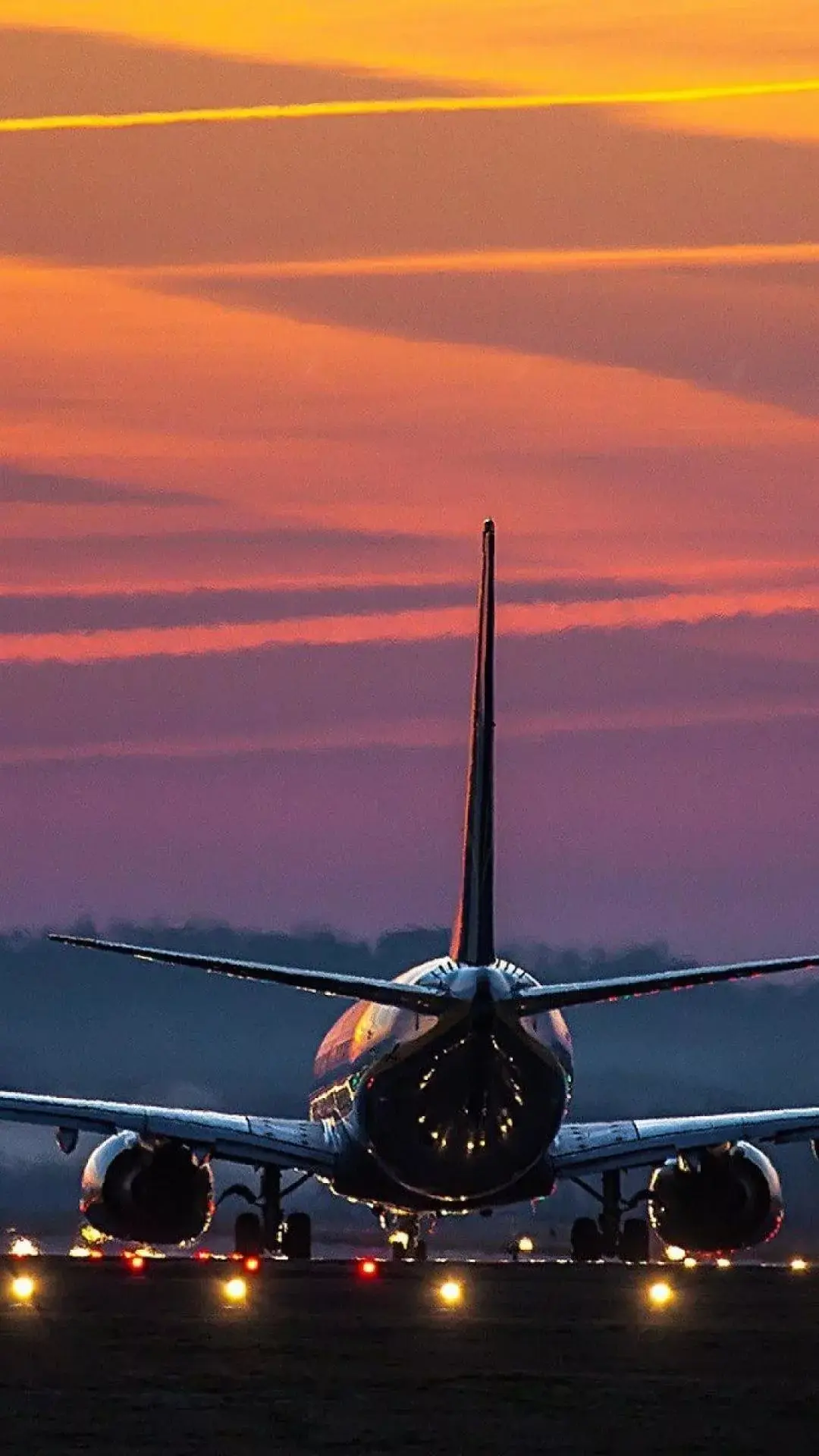 Airplane Flight From Behind Sunset