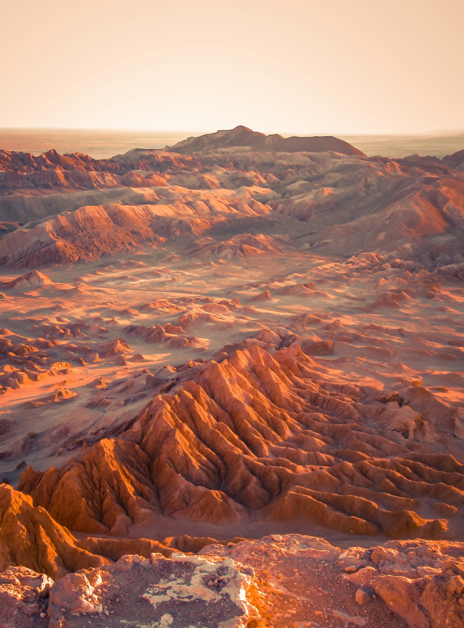 Desert Rock Formations At Sunset With Sun Reflecting Off Sand