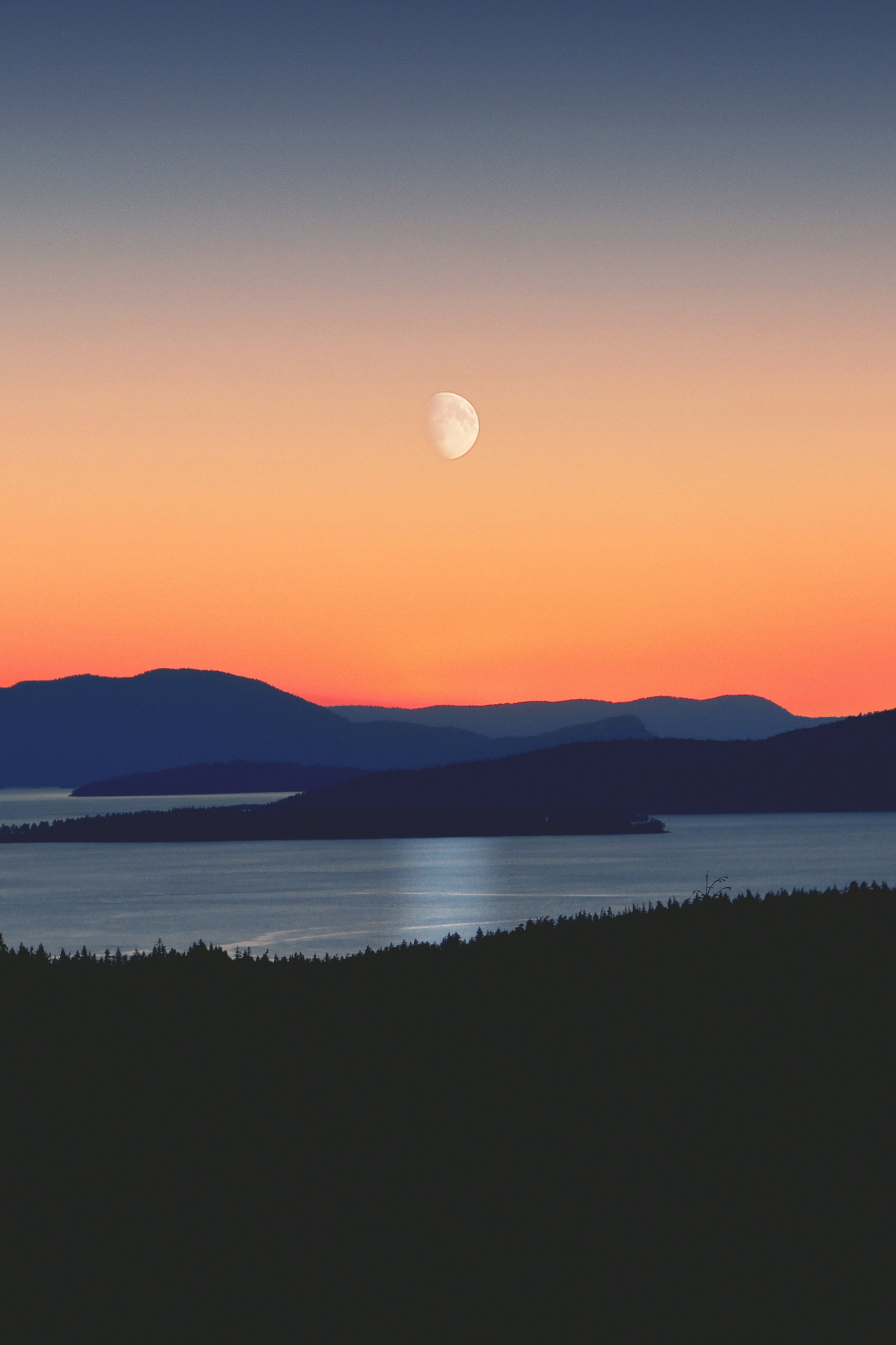 Glowing Reflection Of The Moon Intense Orange Sunset Mountains wallpaper for Apple iPhone, Apple Watch, Mac, iPad and Apple Watch