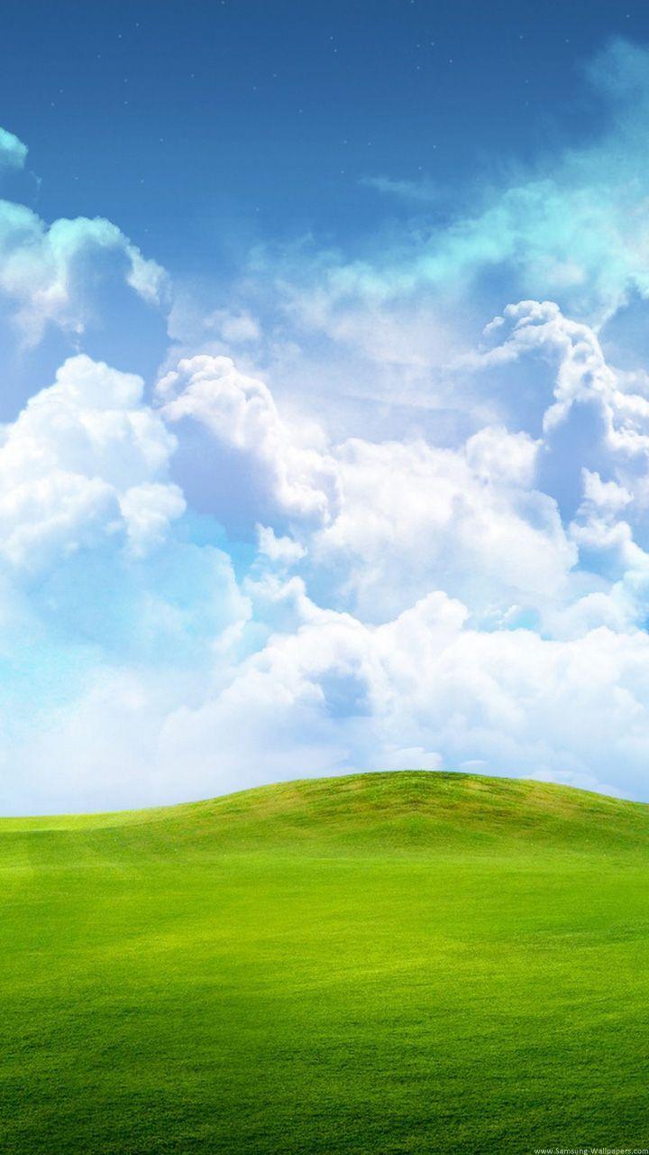 Green Field Of Grass With Blue Sky And Clouds Samsung Galaxy Classic Android Stock wallpaper for Apple iPhone, Apple Watch, Mac, iPad and Apple Watch