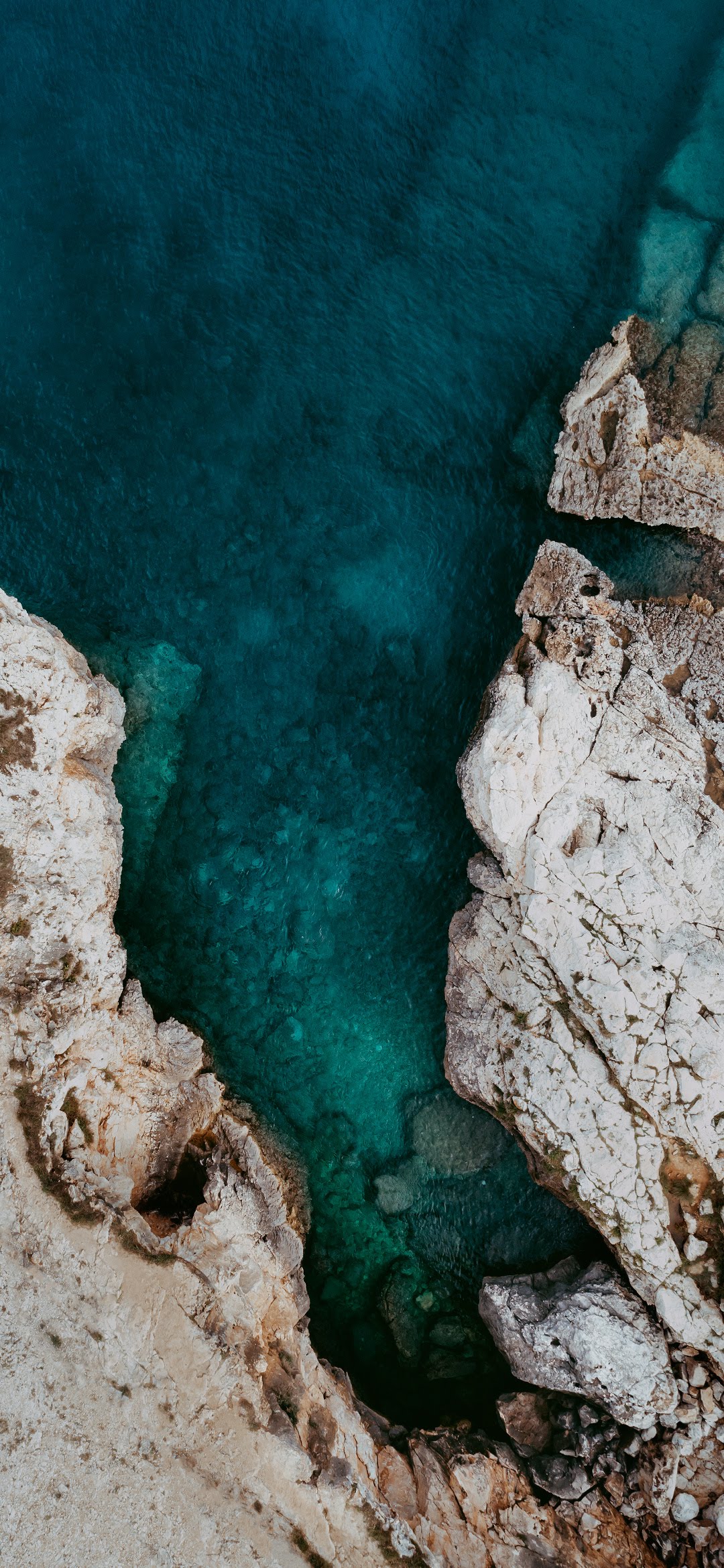 Natural Texture Cliffside Rocks Meets The Ocean From Above wallpaper for Apple iPhone, Apple Watch, Mac, iPad and Apple Watch