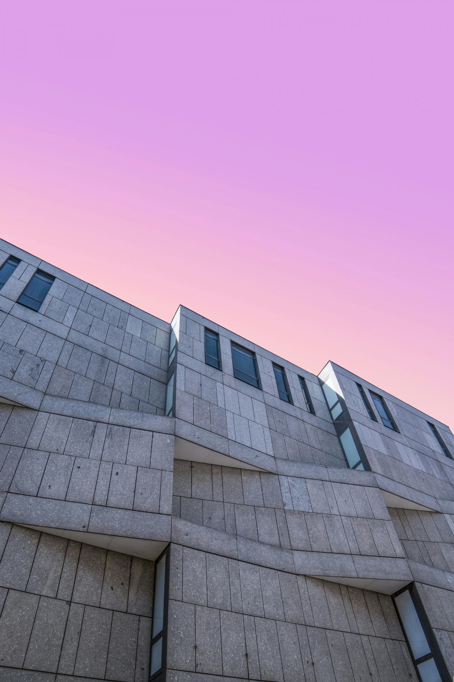 Pink Sunrise Above Brutalist Concrete Architecture