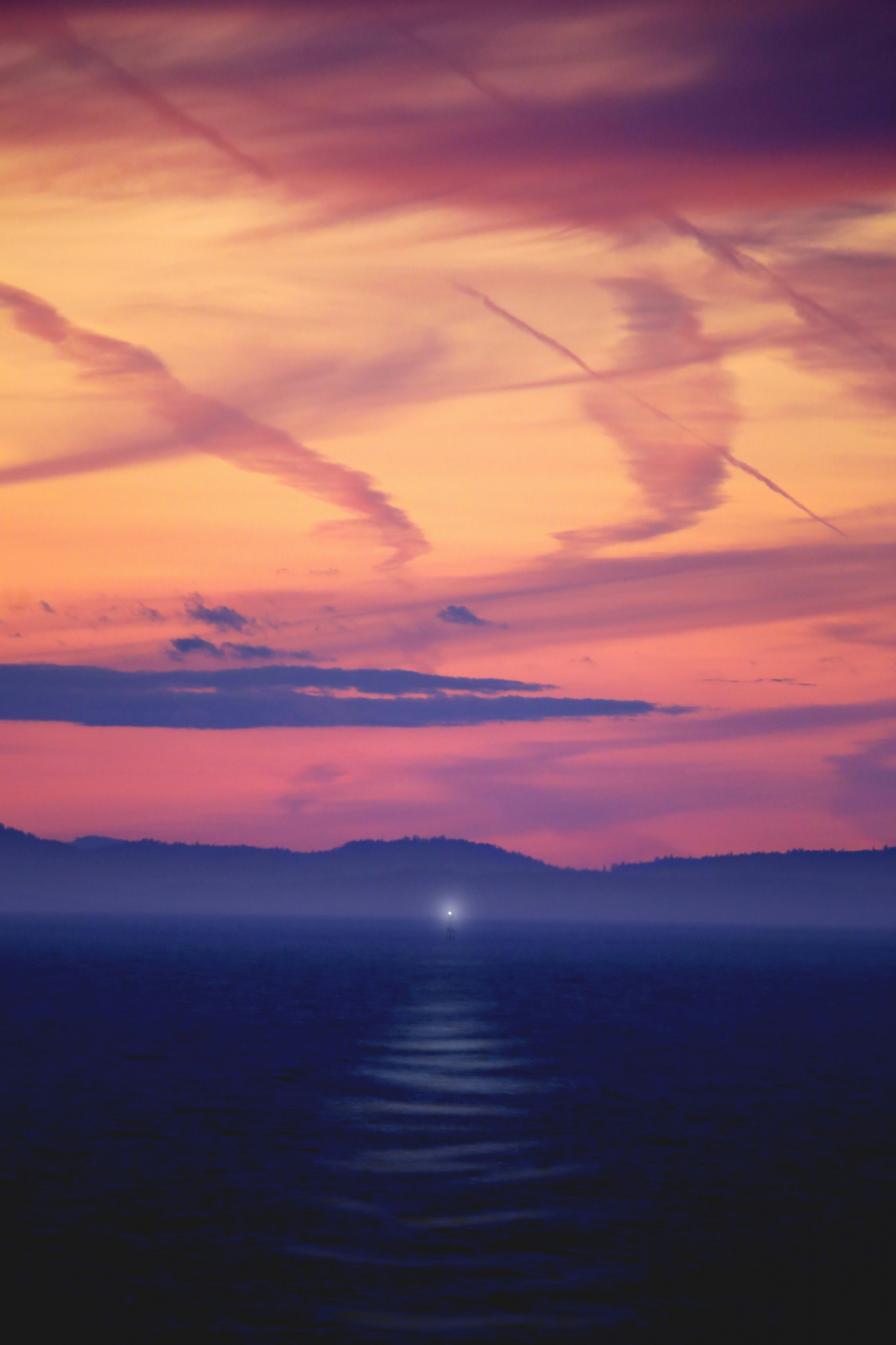 Pretty Clouds At Sunset Over The Ocean Lighthouse