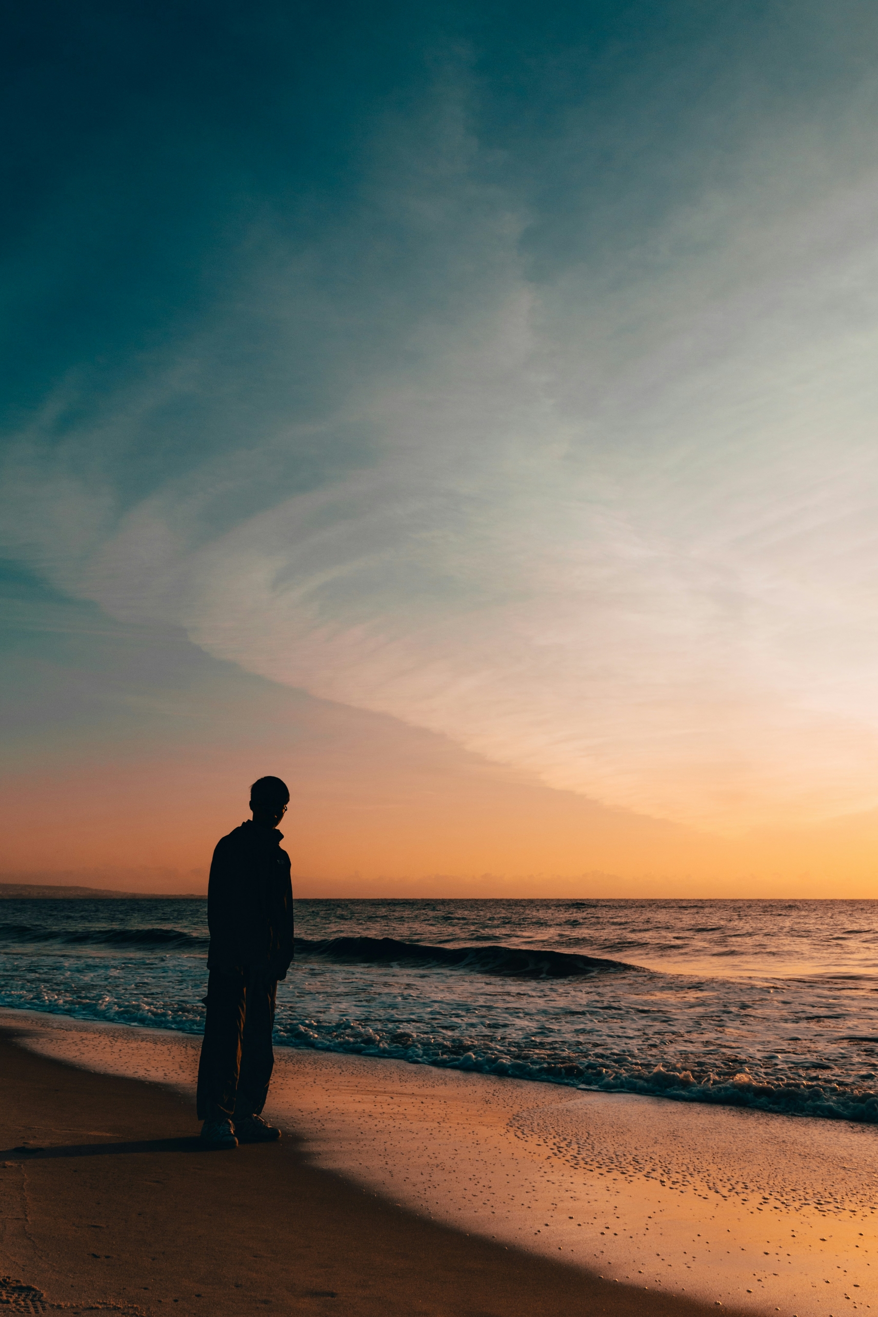 Silhouette Of A Man At Sunset On The Beach wallpaper for Apple iPhone, Apple Watch, Mac, iPad and Apple Watch