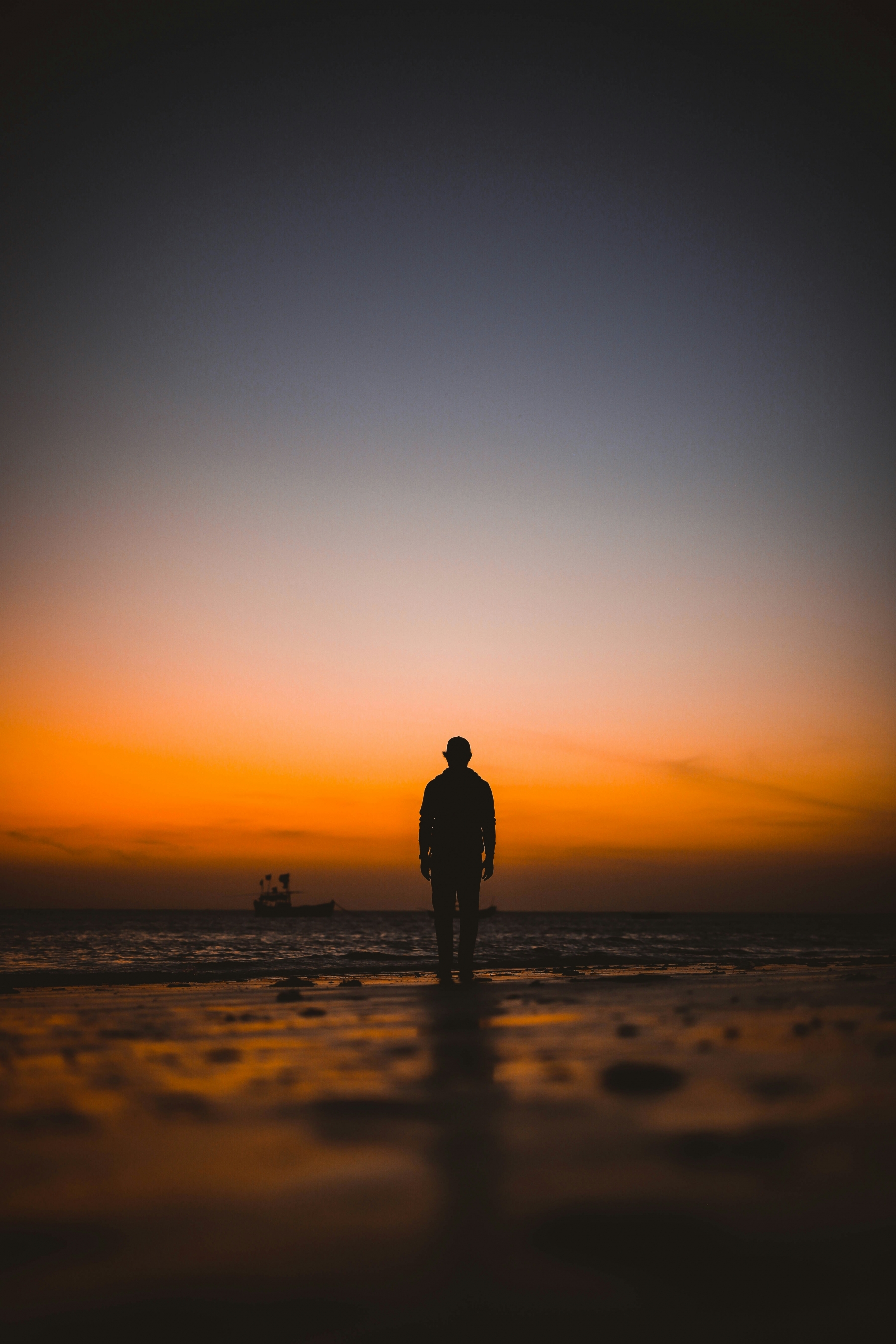 Silhouette Of A Man Walking On The Beach At Sunset Pro Photography wallpaper for Apple iPhone, Apple Watch, Mac, iPad and Apple Watch