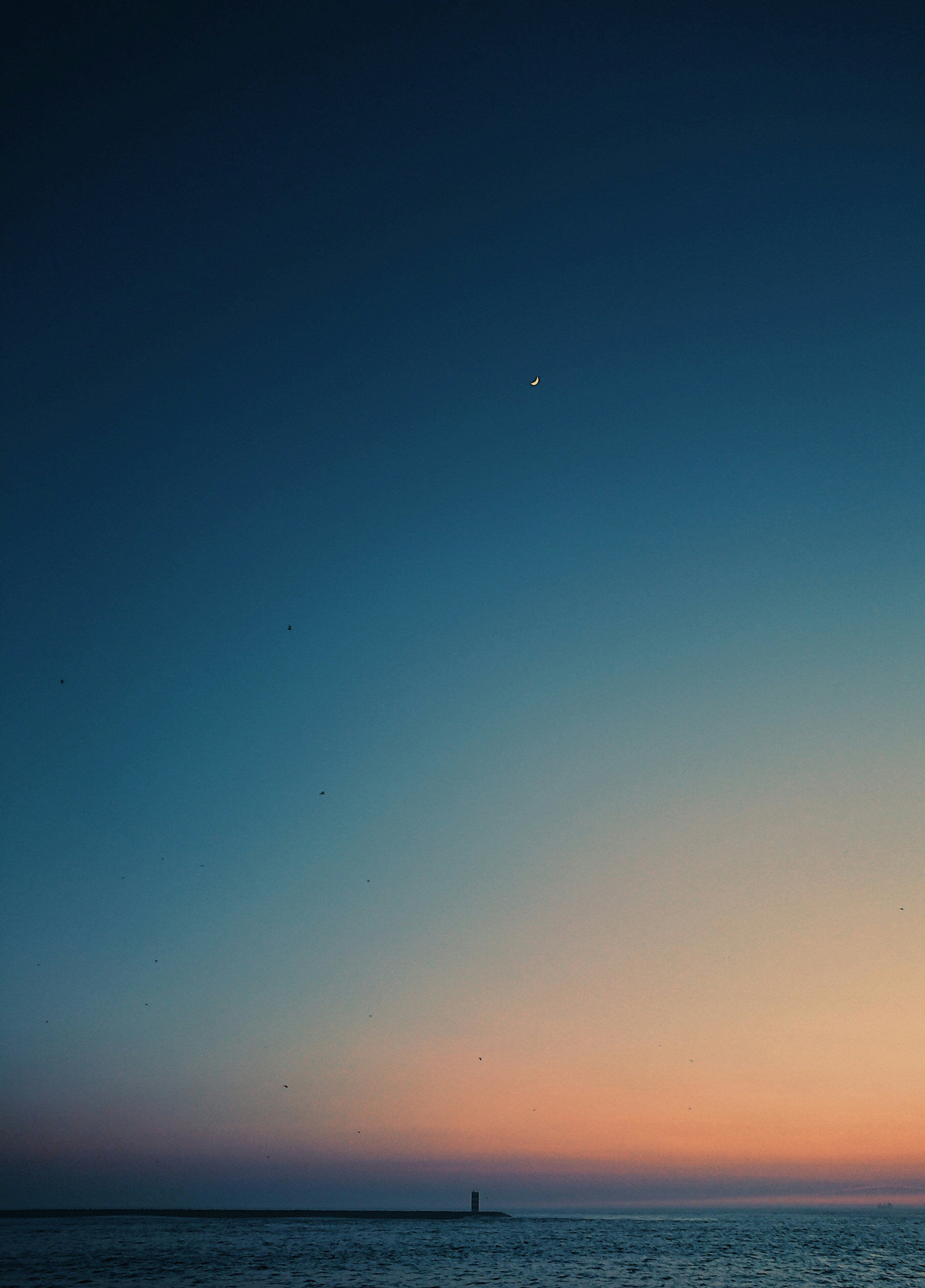 Tiny Lighthouse In The Distance At Sunset Tiny Moon wallpaper for Apple iPhone, Apple Watch, Mac, iPad and Apple Watch