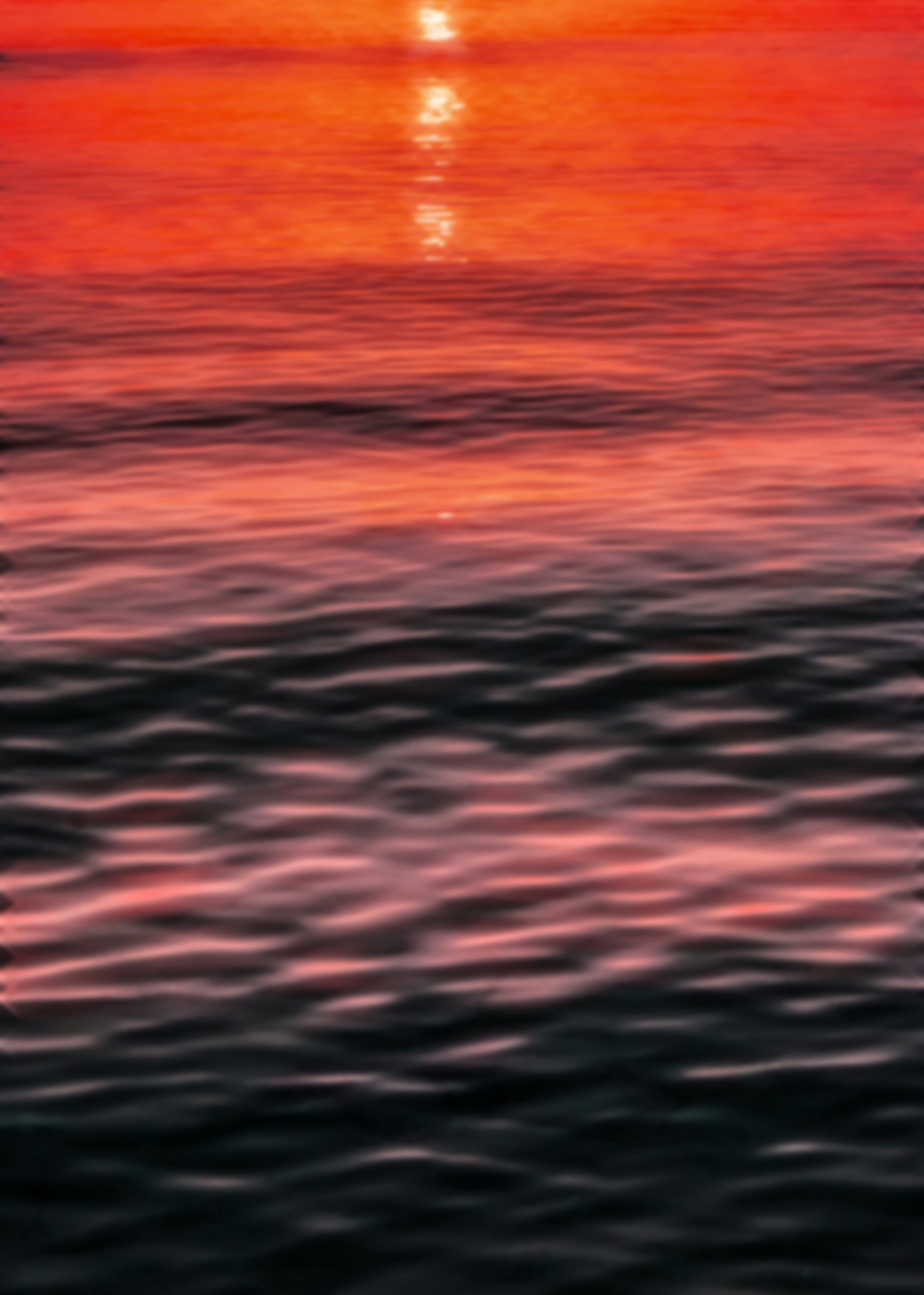 Vibrant Orange Sunset Reflected Off The Ocean