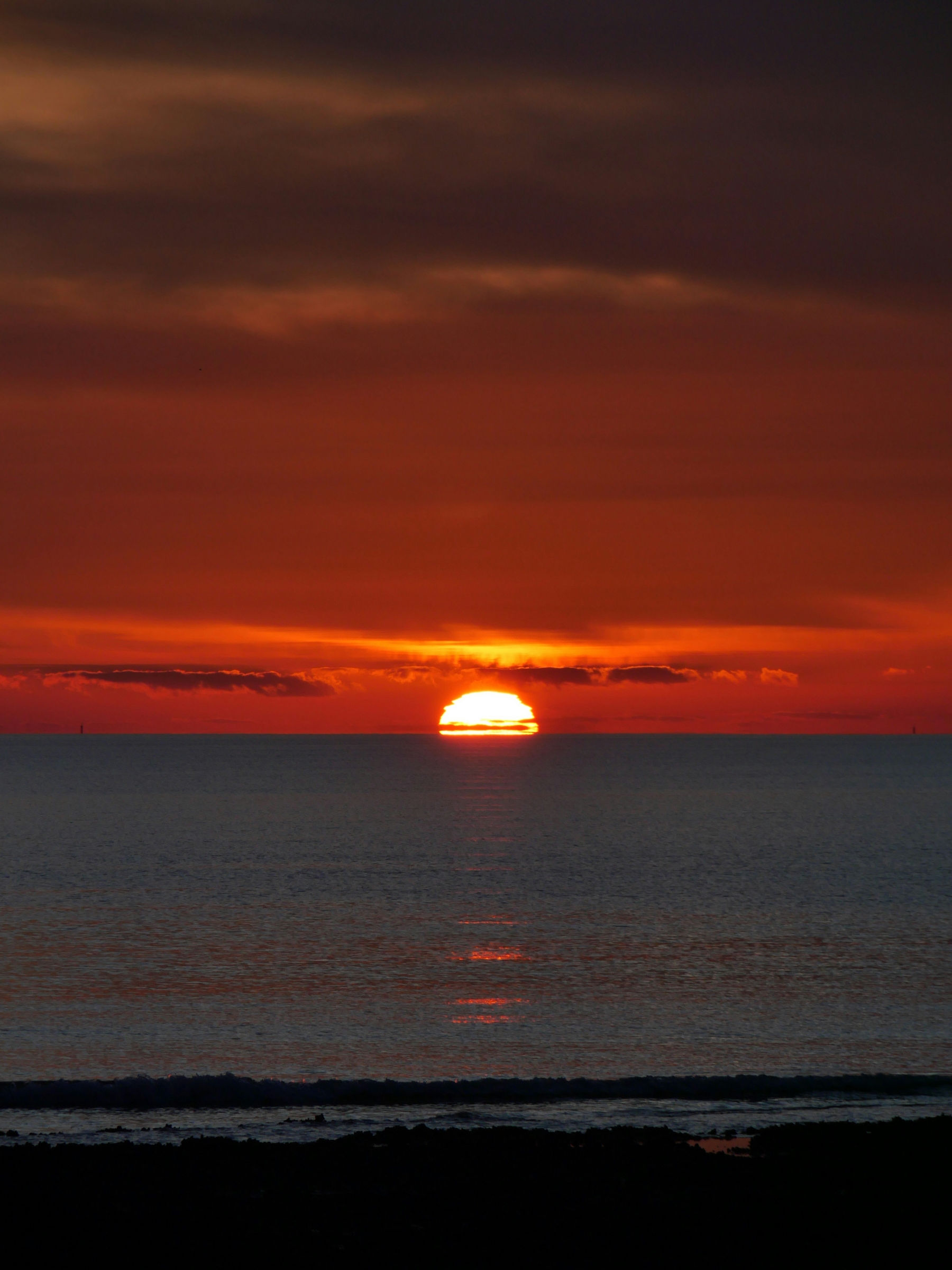 Vibrant White Orange Sunset Over The Ocean Water