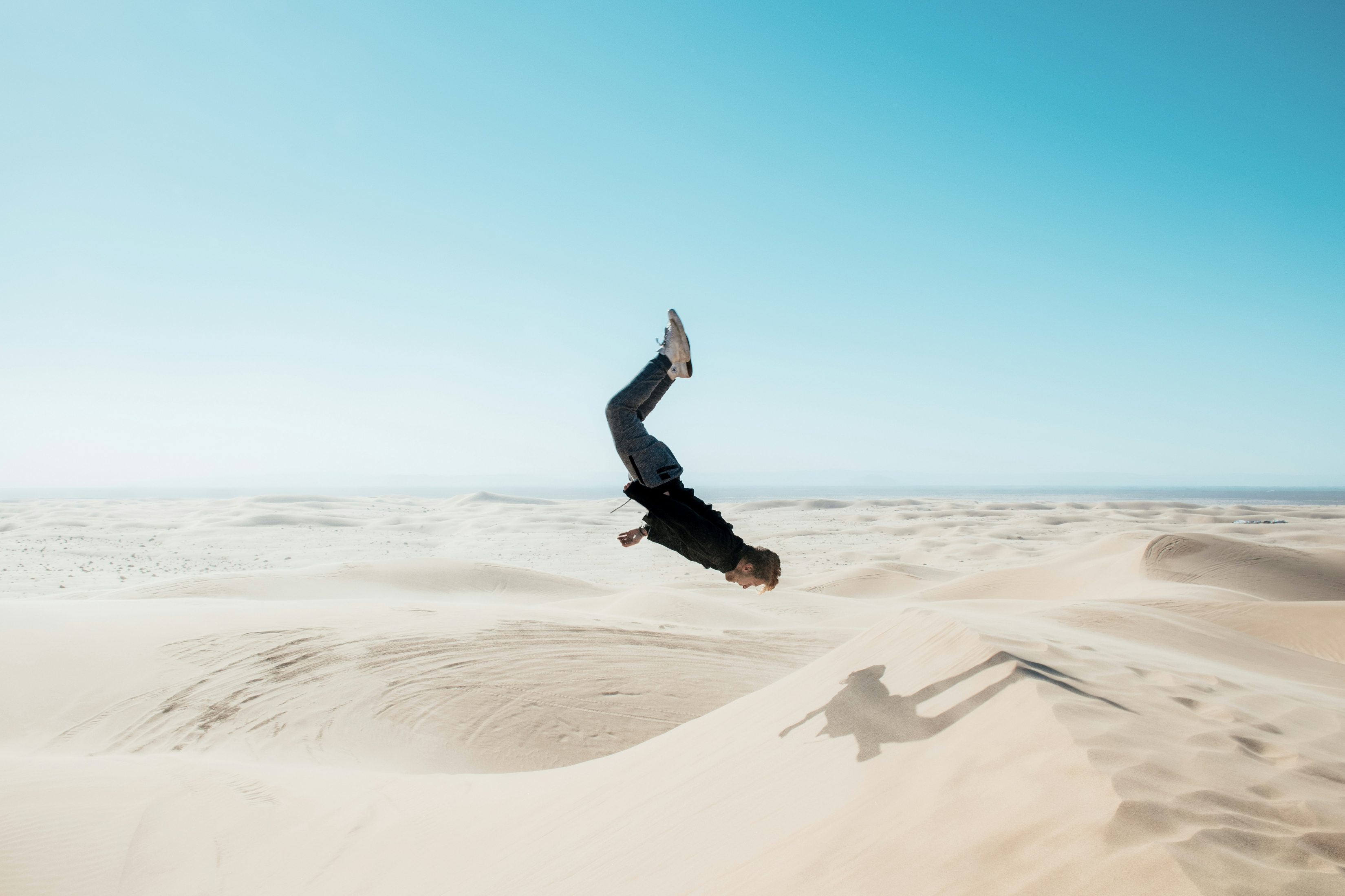 A Guy Does A Flip In The Desert wallpaper for Apple iPhone, Apple Watch, Mac, iPad and Apple Watch