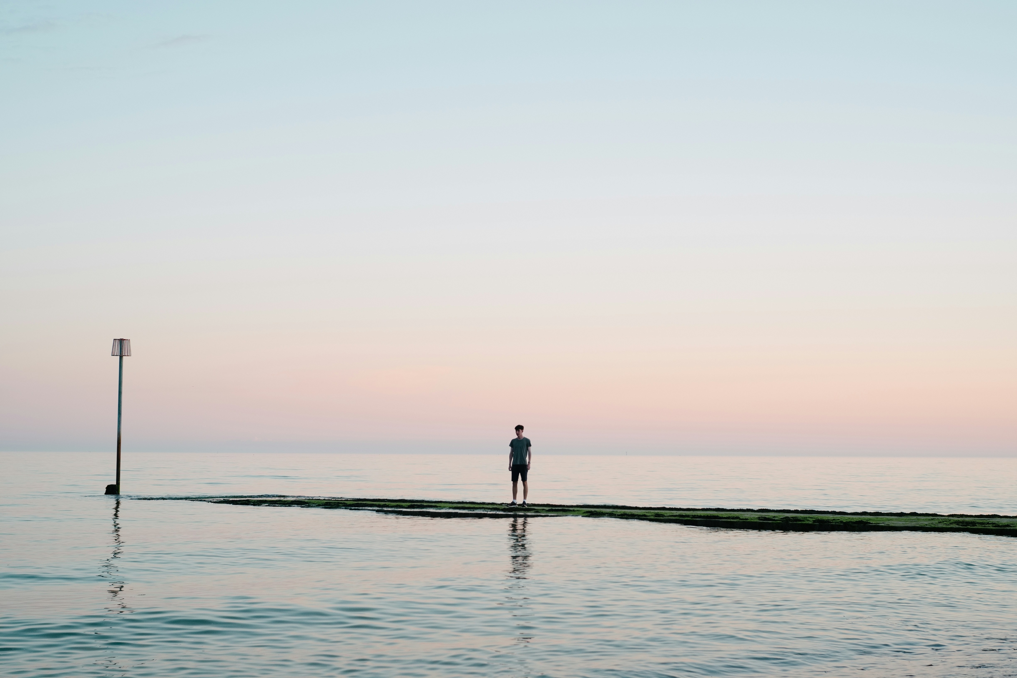 A Man On A Small Ocean Island At Sunrise wallpaper for Apple iPhone, Apple Watch, Mac, iPad and Apple Watch