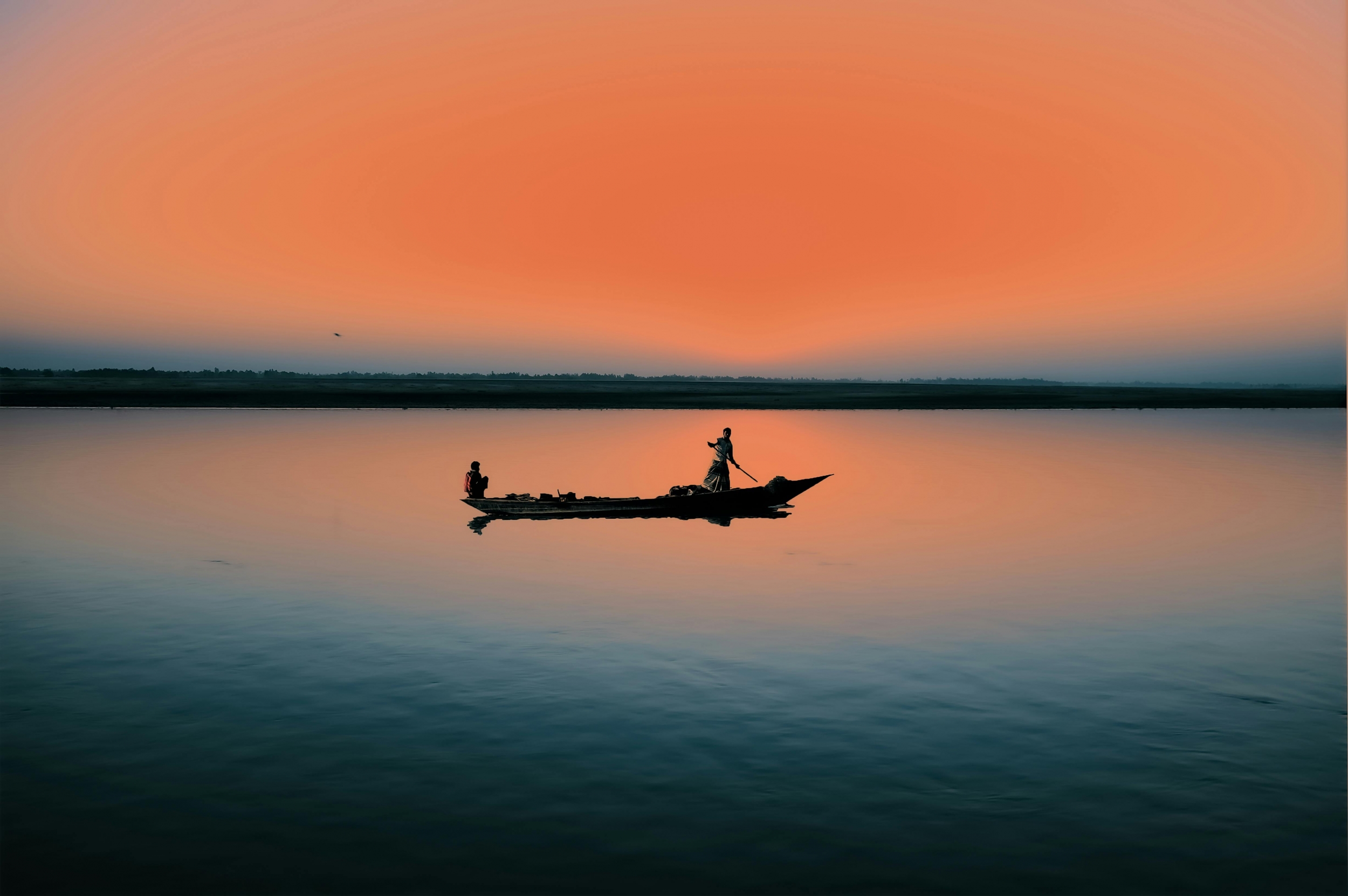 A Man Sails In The Sunset Vibrant Orange Sunset