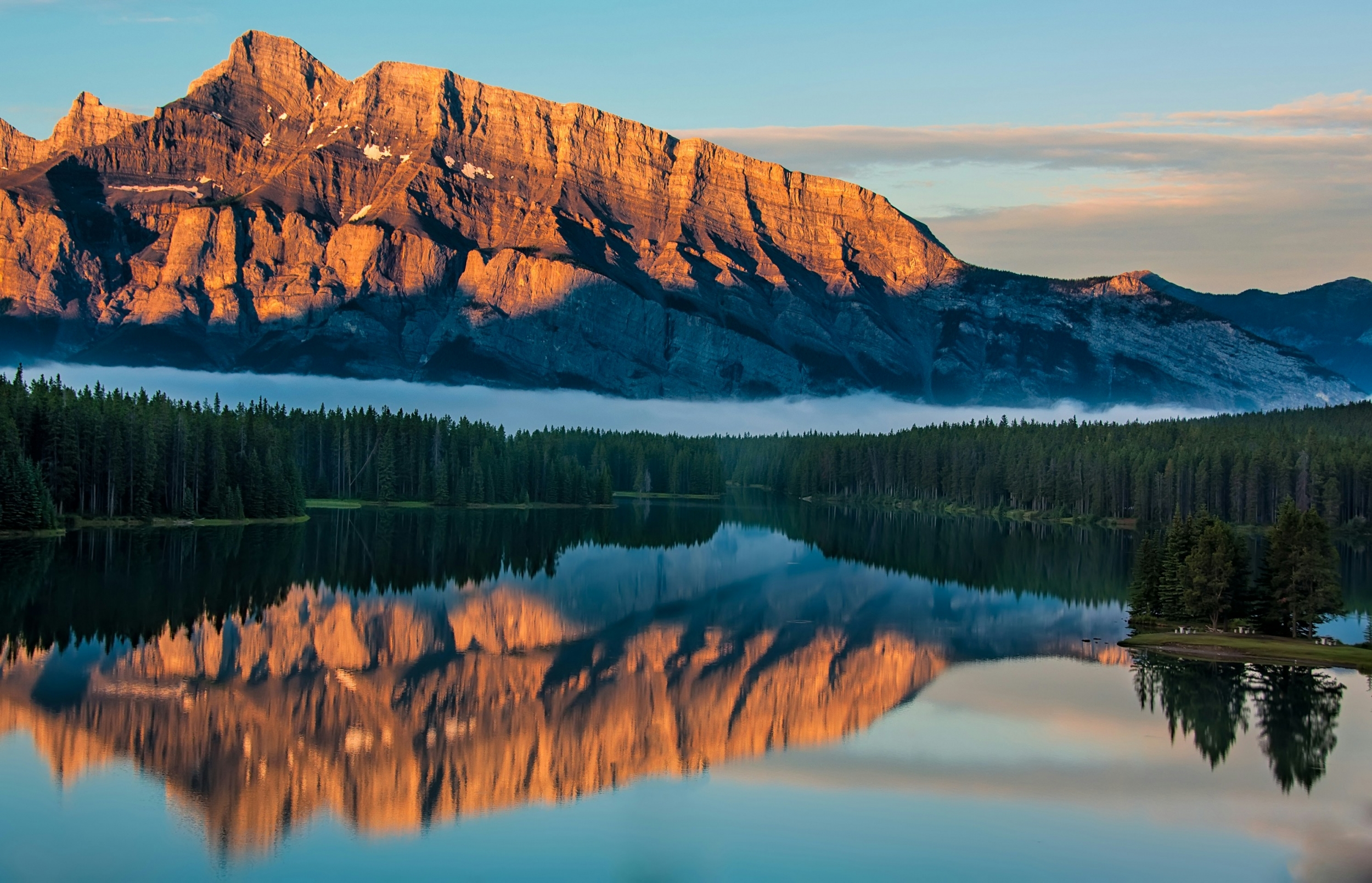 A Mountain Reflects Off The Lake At Golden Hour In United States