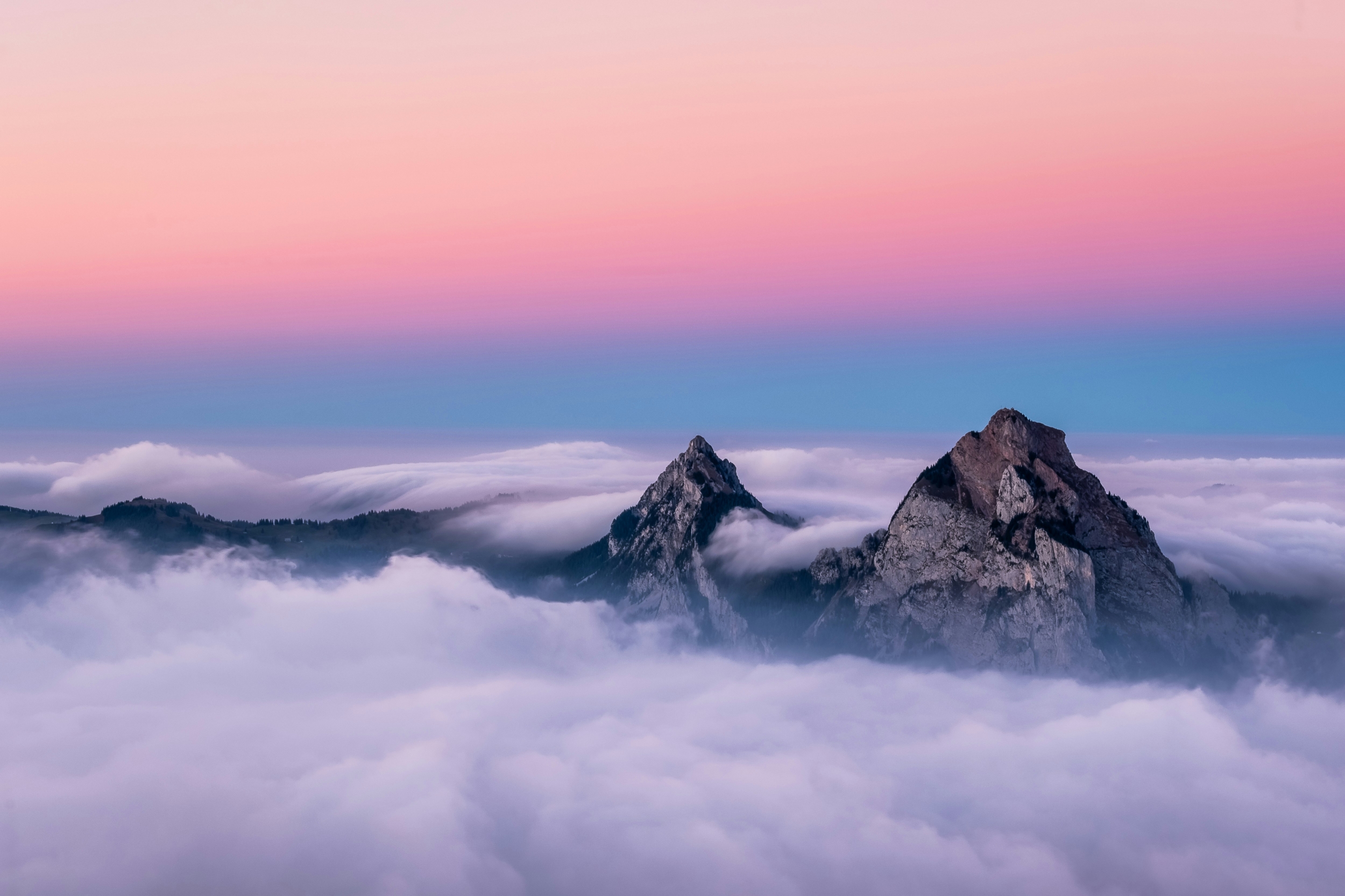 Colorful Sunrise Hues Over The Clouds With Mountaintop