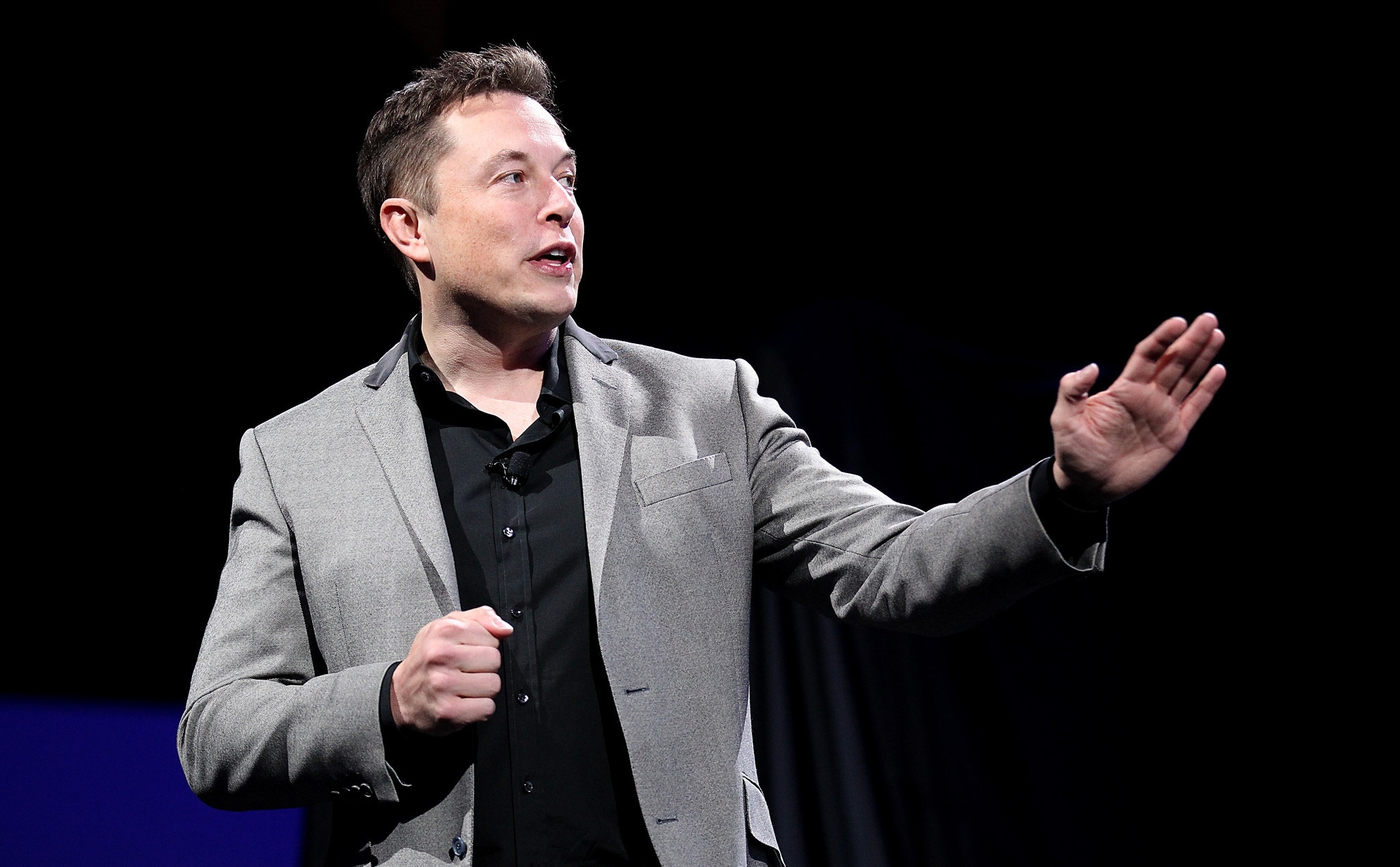 Elon Musk Speaking On Black Background wallpaper for Apple iPhone, Apple Watch, Mac, iPad and Apple Watch