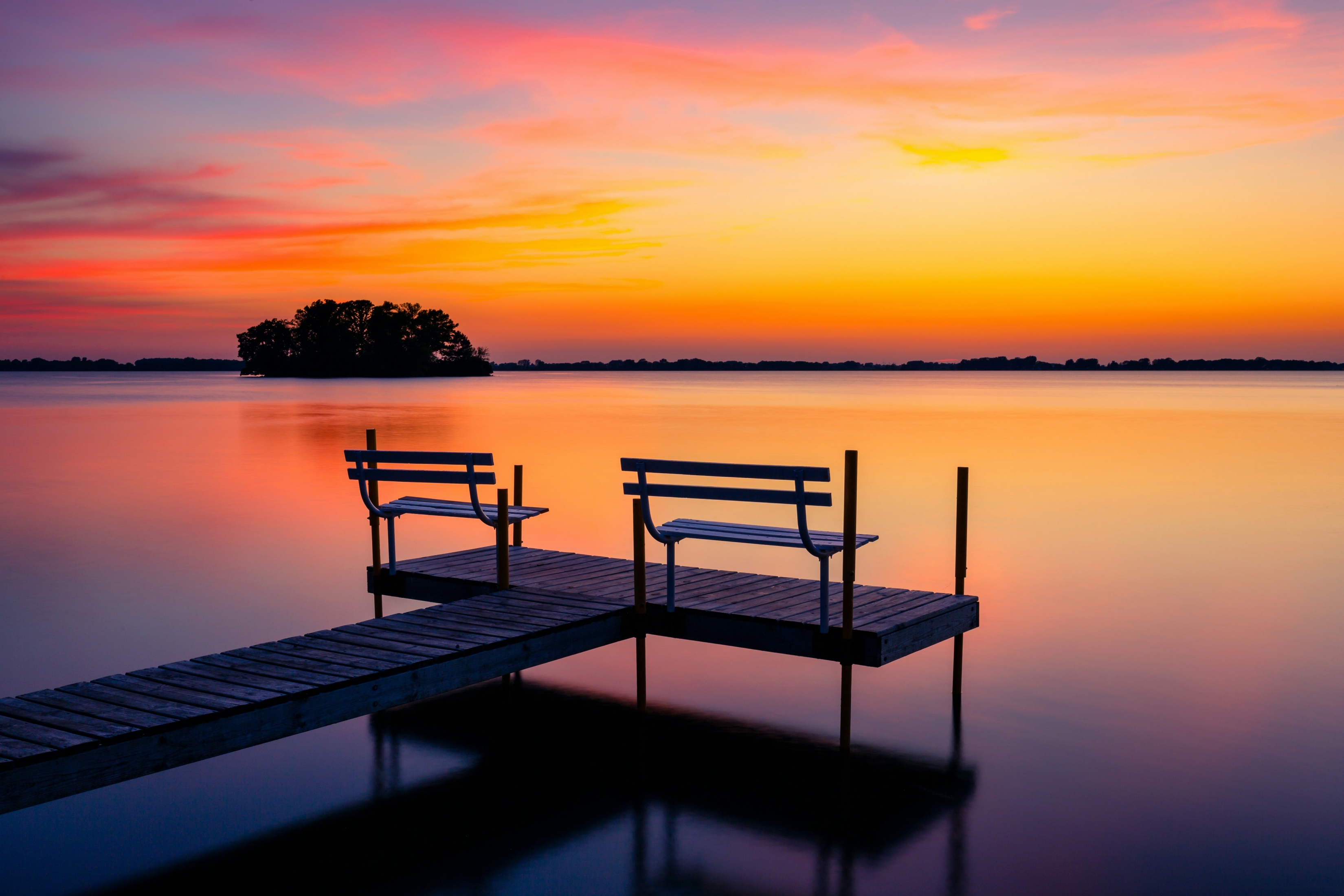 Extremely Vibrant Sunset Reflecting On The Still Water Lake wallpaper for Apple iPhone, Apple Watch, Mac, iPad and Apple Watch