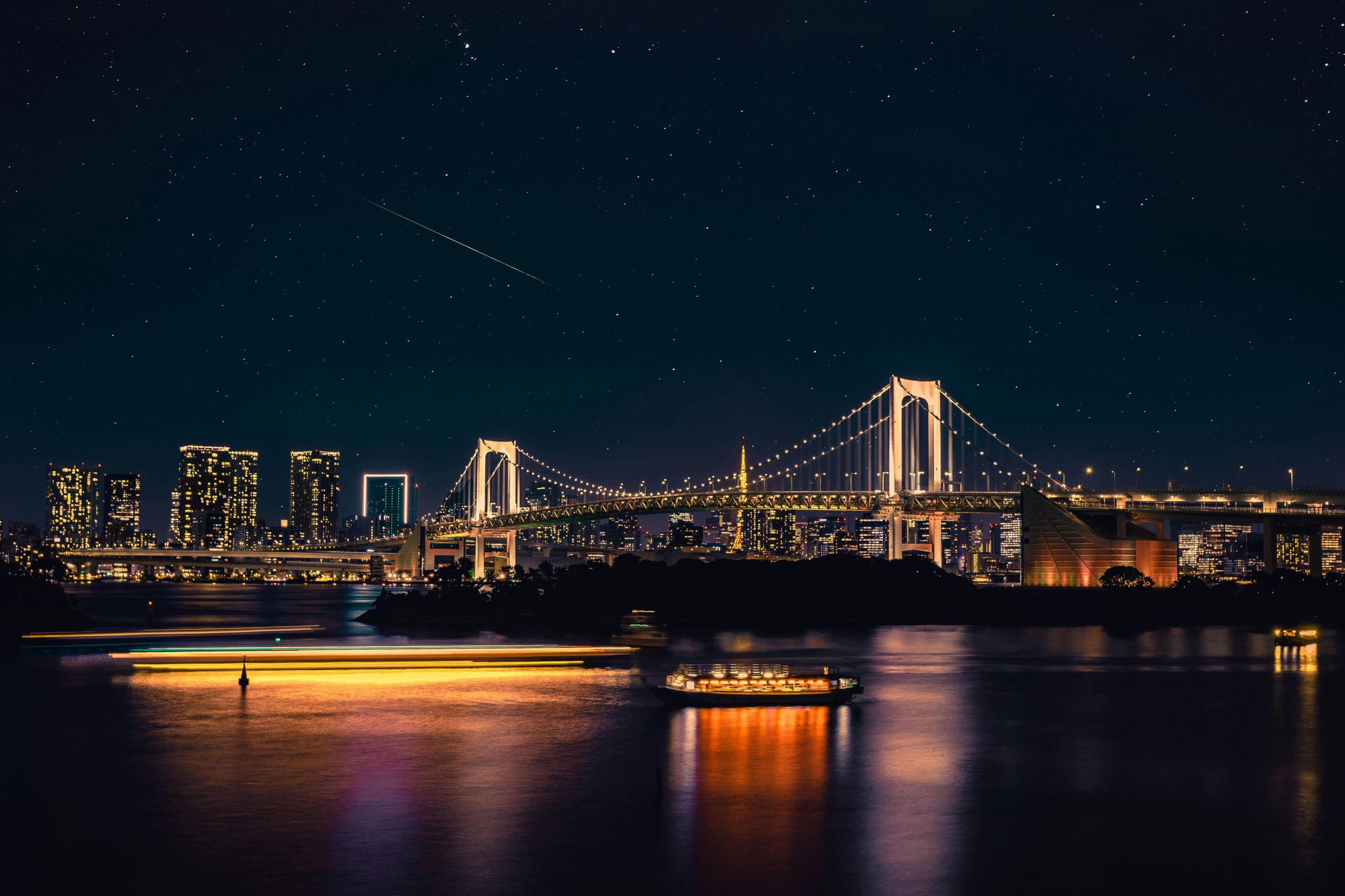 Lit Up City Bridge At Night With Shooting Star