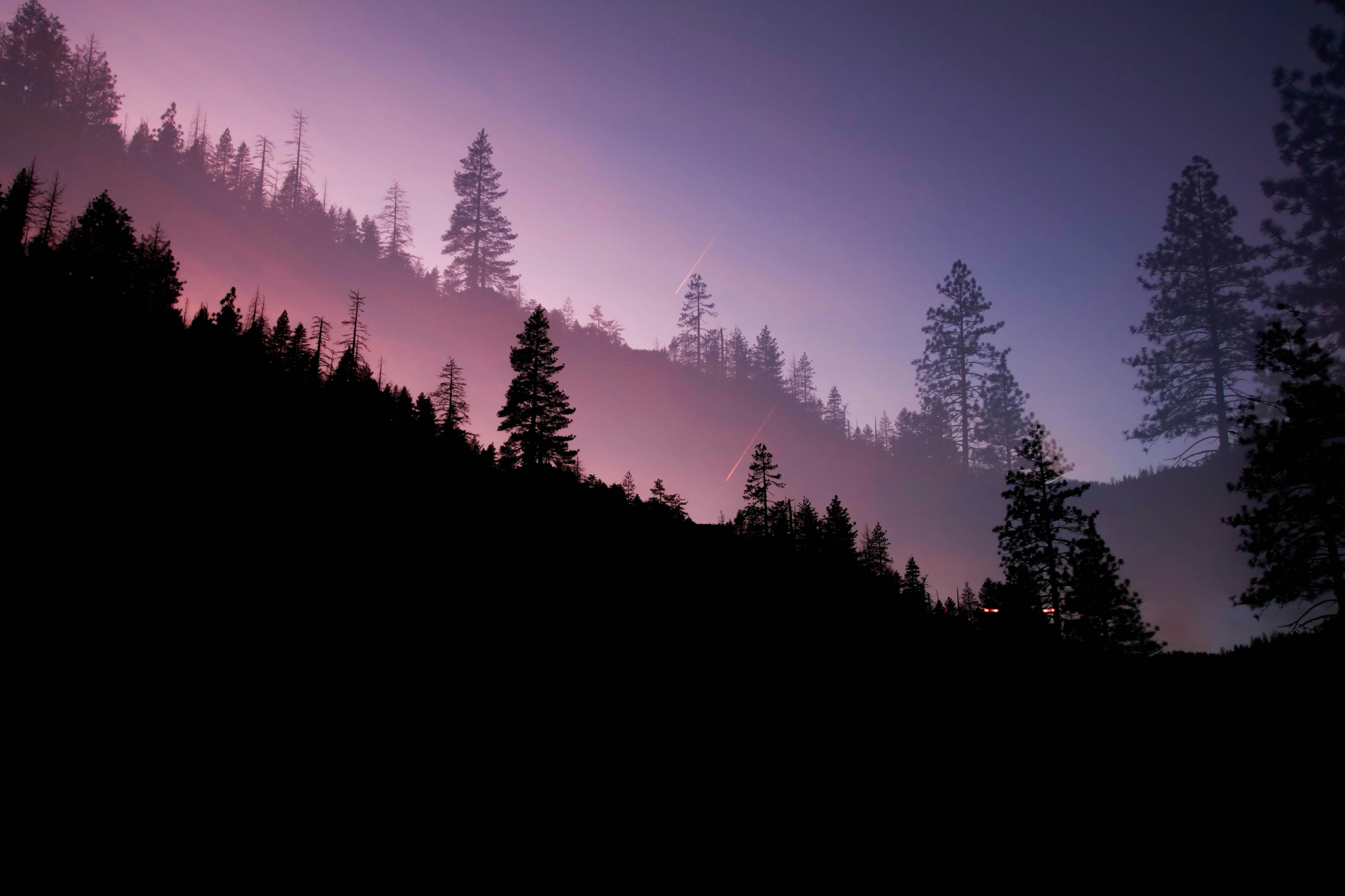 Mountain And Trees Silhouette Against The Sunset