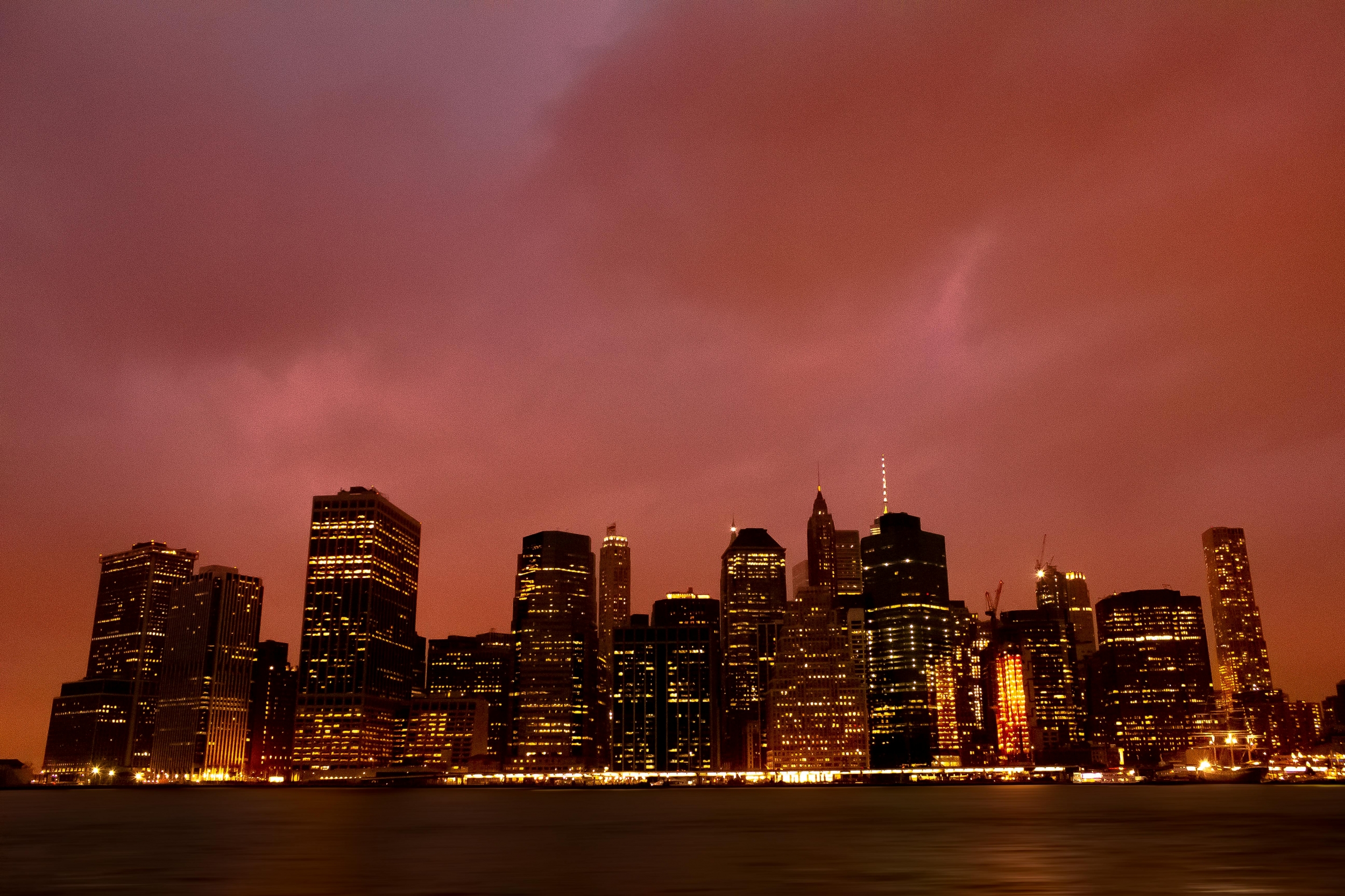 Red Sky Over The City At Night With City Lights