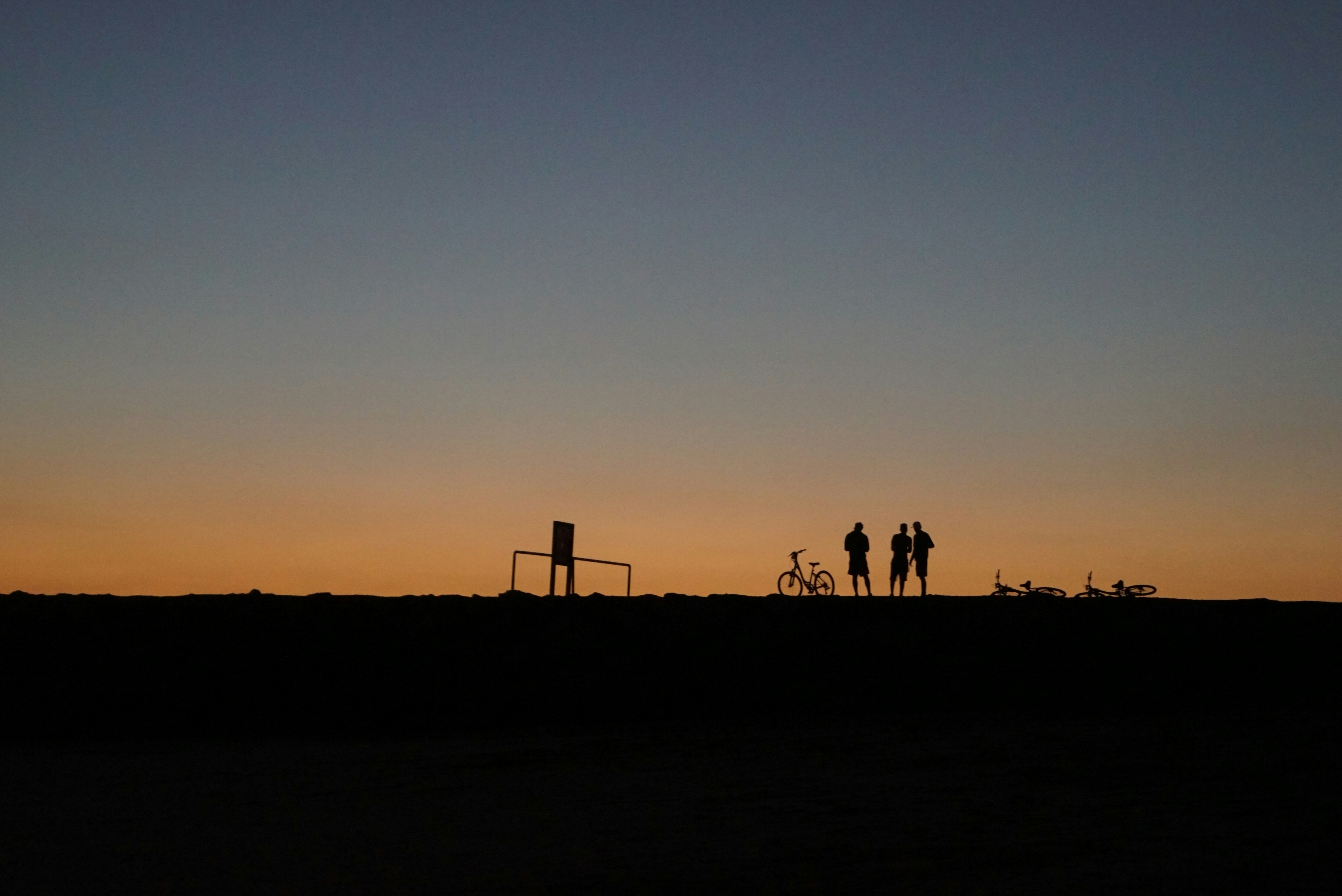 Silhouette Of Friends At Sunset