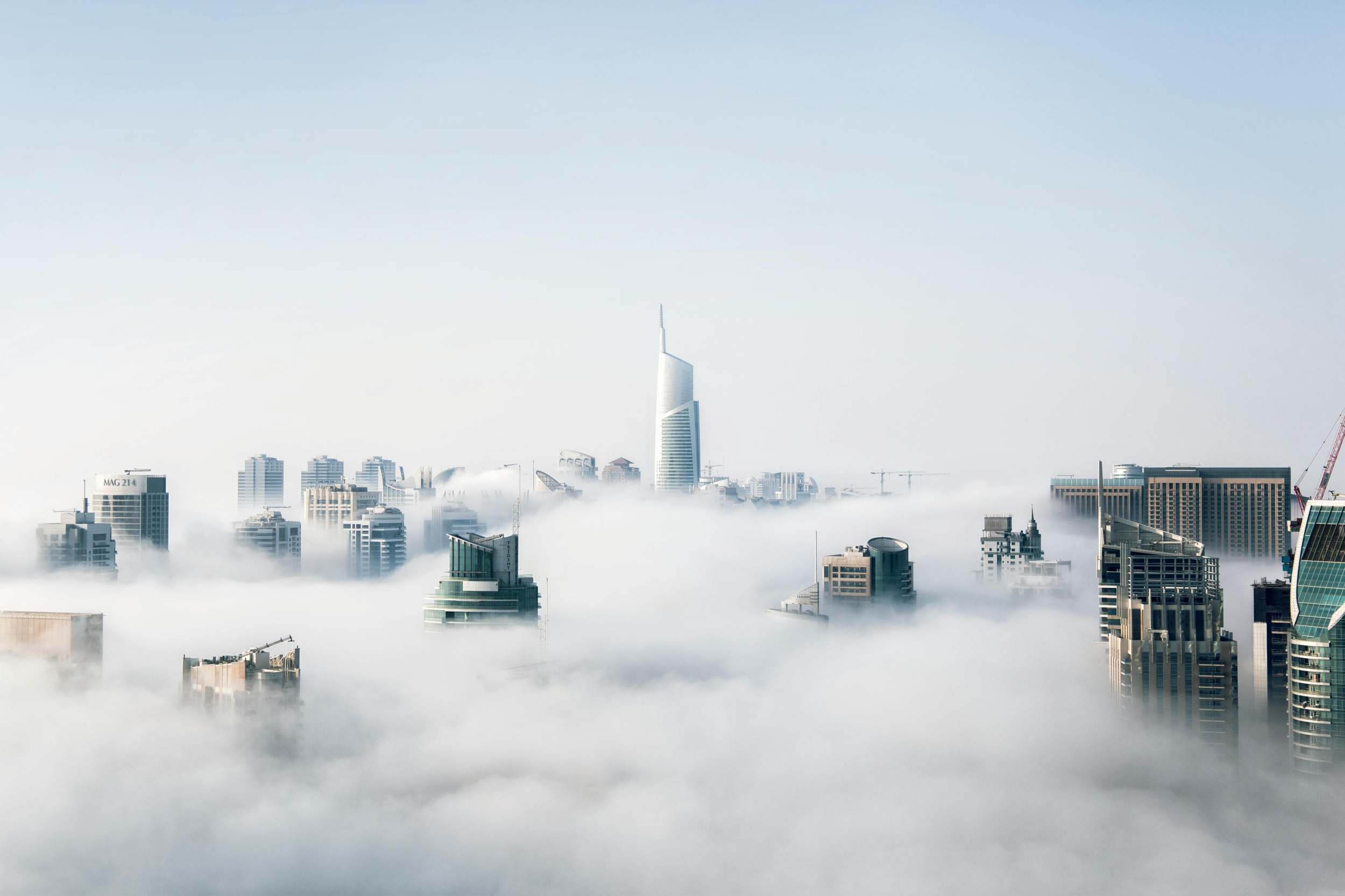 Skyscraper Cityscape Peeking Above The Clouds On A Misty Morning wallpaper for Apple iPhone, Apple Watch, Mac, iPad and Apple Watch