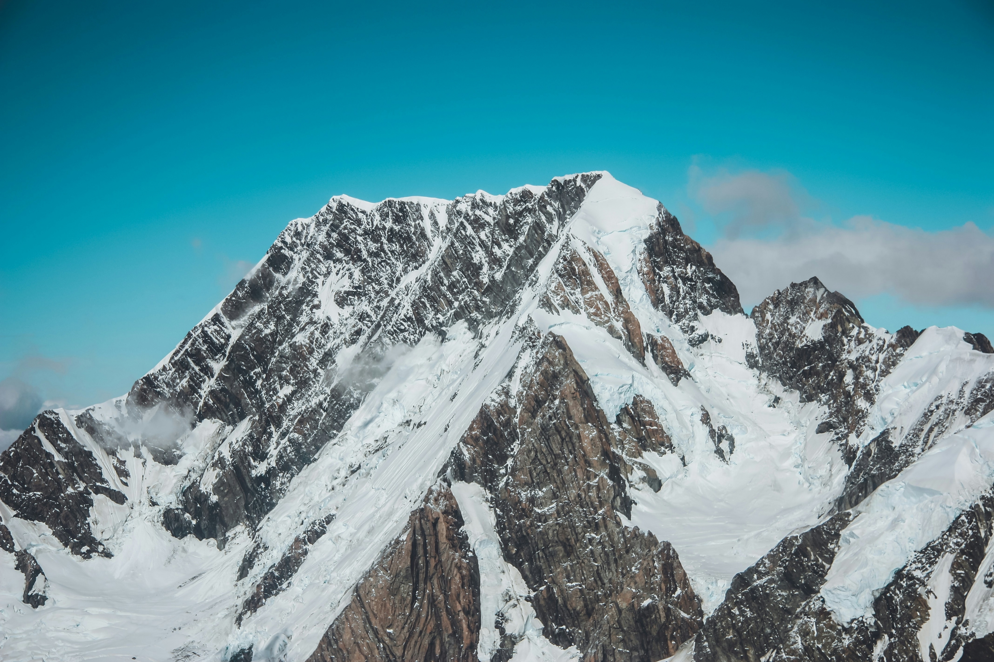 Snow Covered Mountain With Clouds And Blue Sky