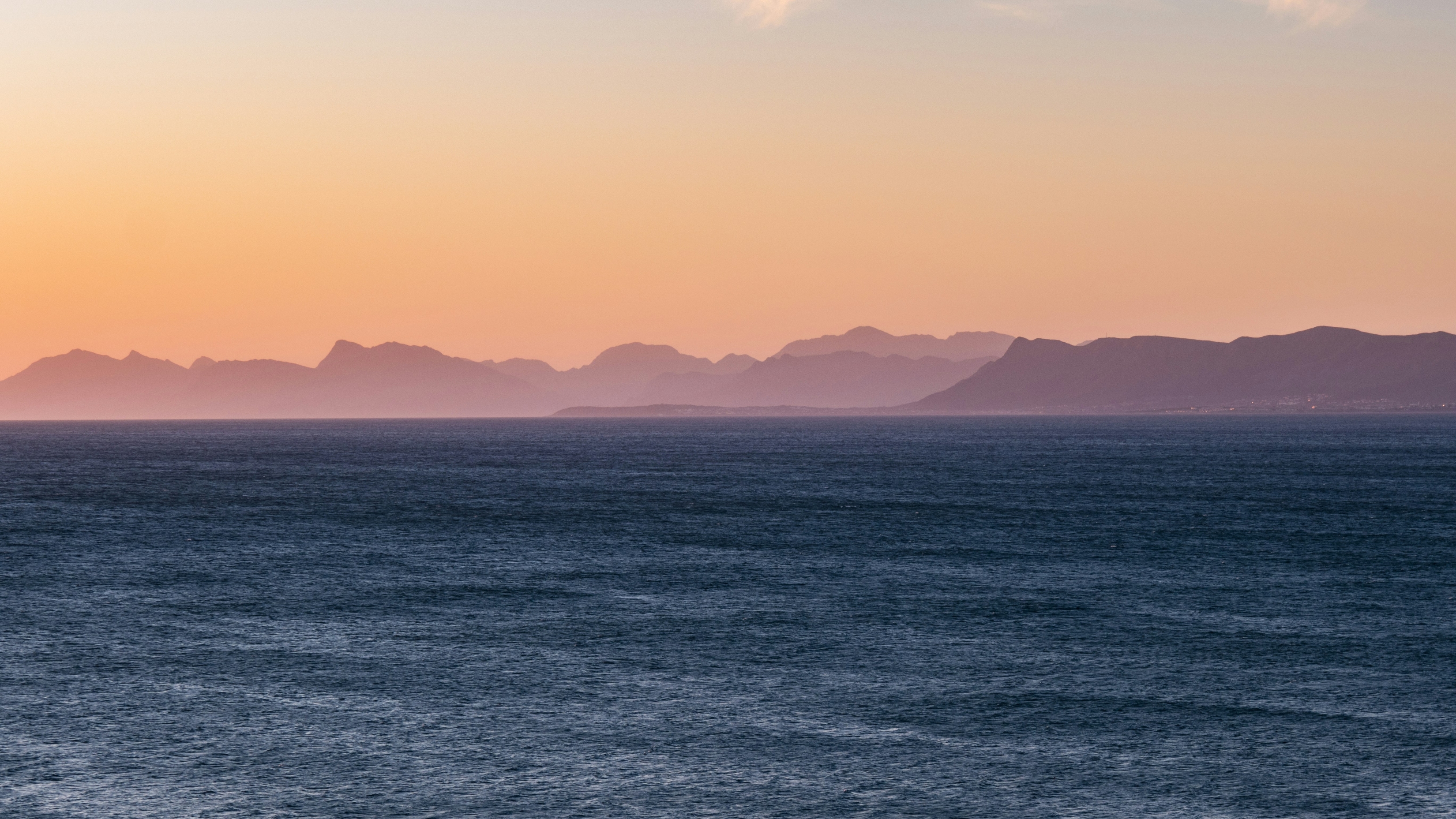 Sunset Mountains And Intense Ocean 6K wallpaper for Apple iPhone, Apple Watch, Mac, iPad and Apple Watch