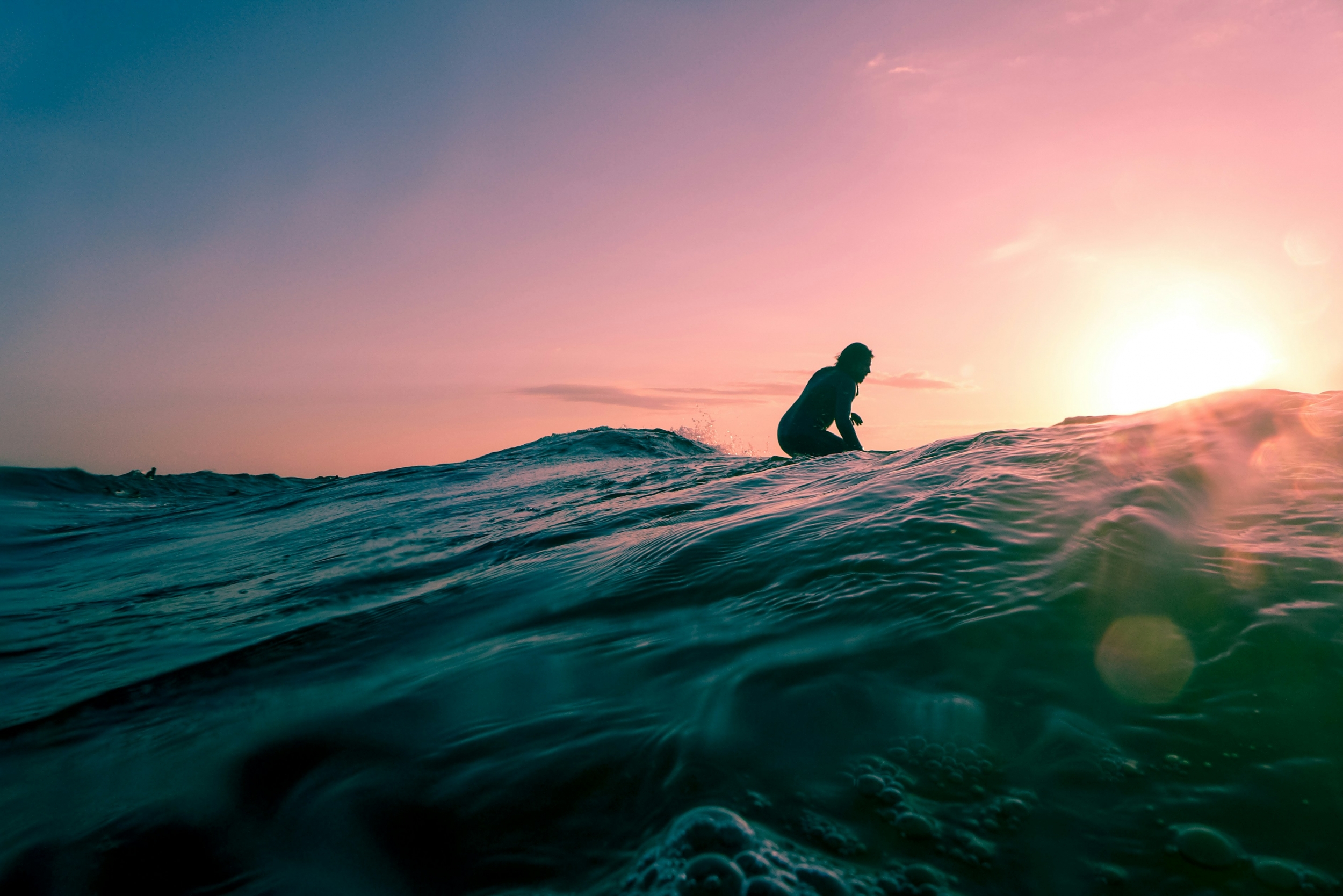 Surfer Riding Waves At Sunset Vibrant