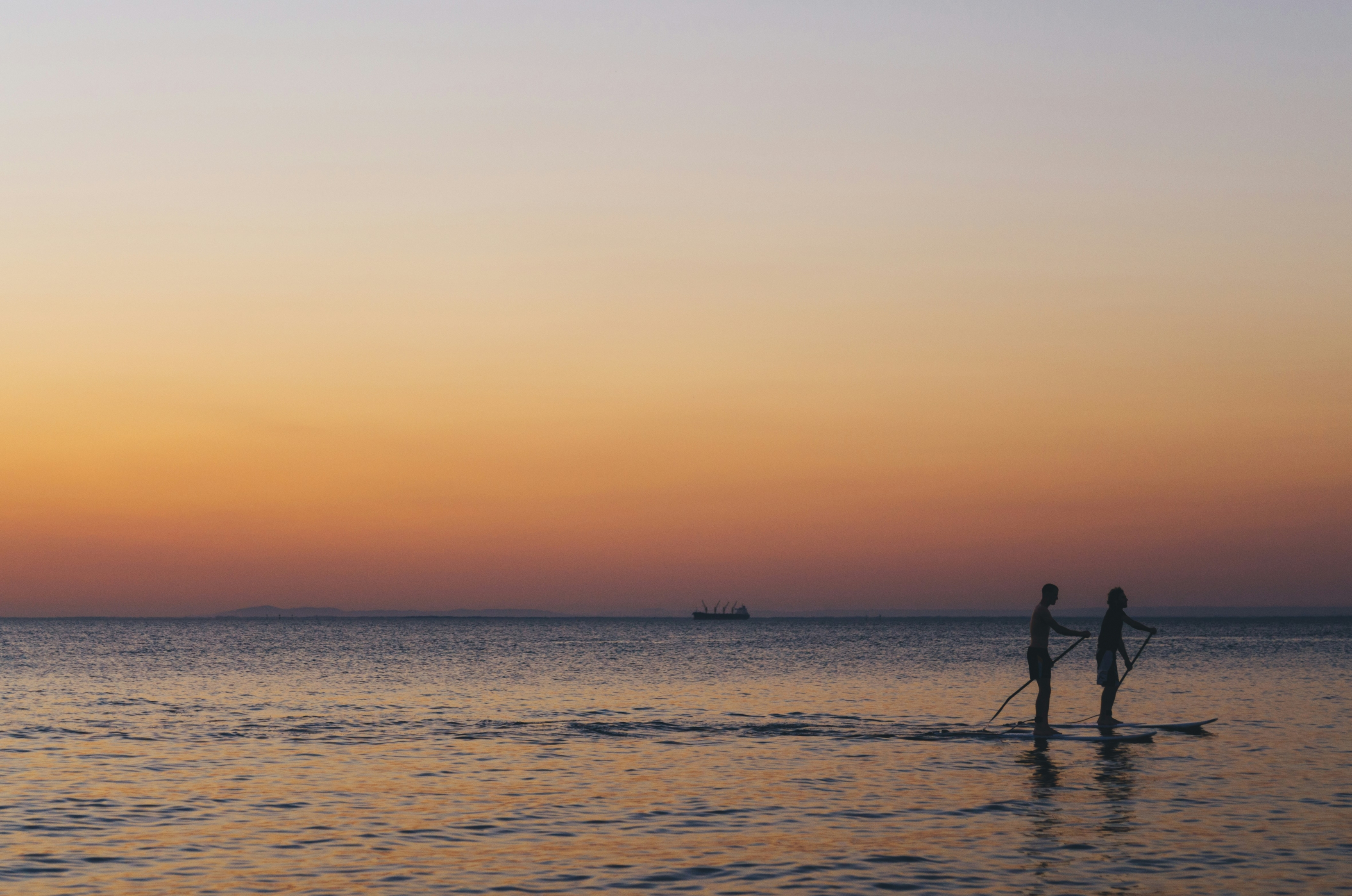 Two People Surfing At Sunset Couple Love