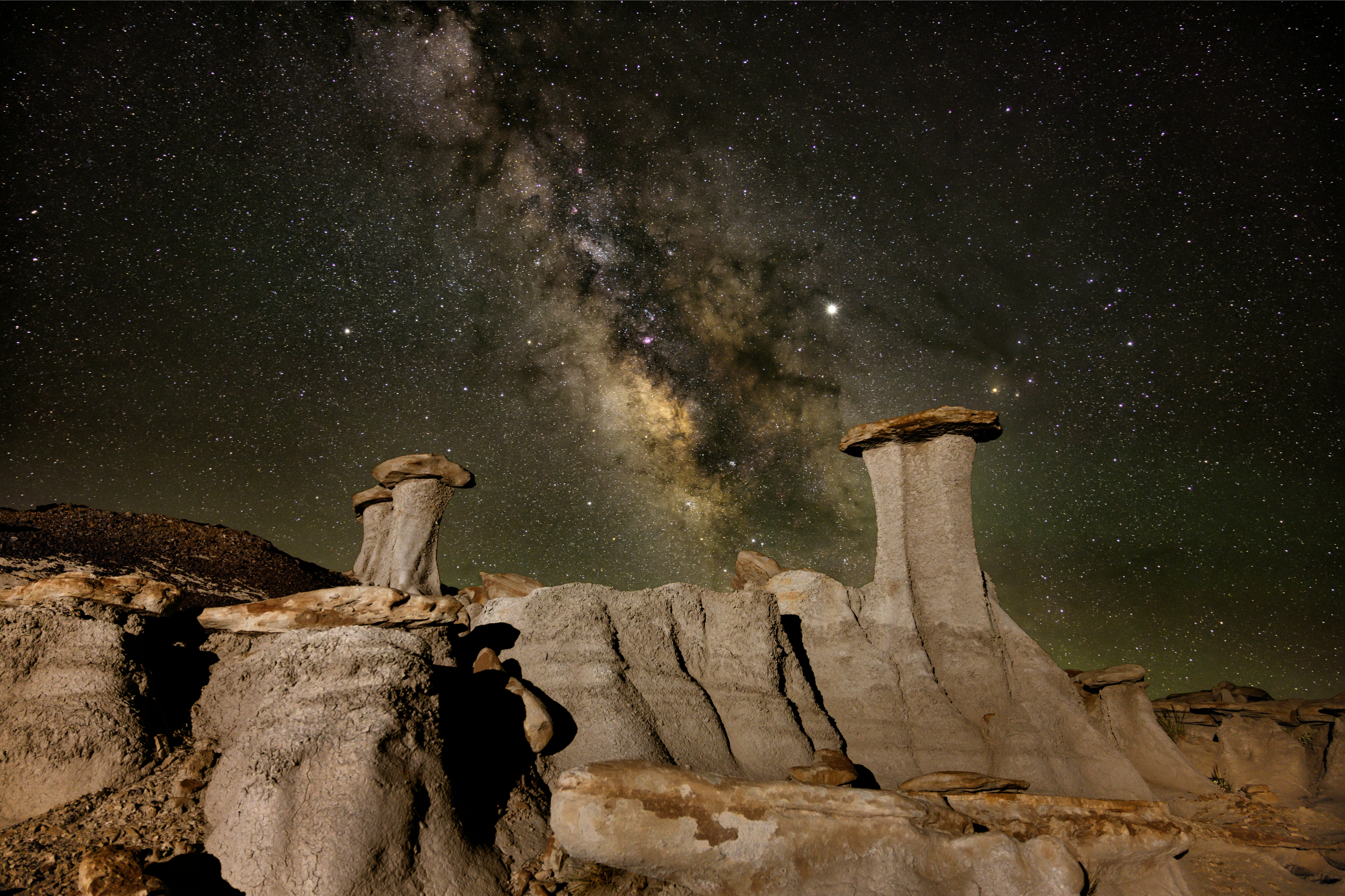 Unique Rock Formations In The Desert At Night Vibrant Night Sky wallpaper for Apple iPhone, Apple Watch, Mac, iPad and Apple Watch