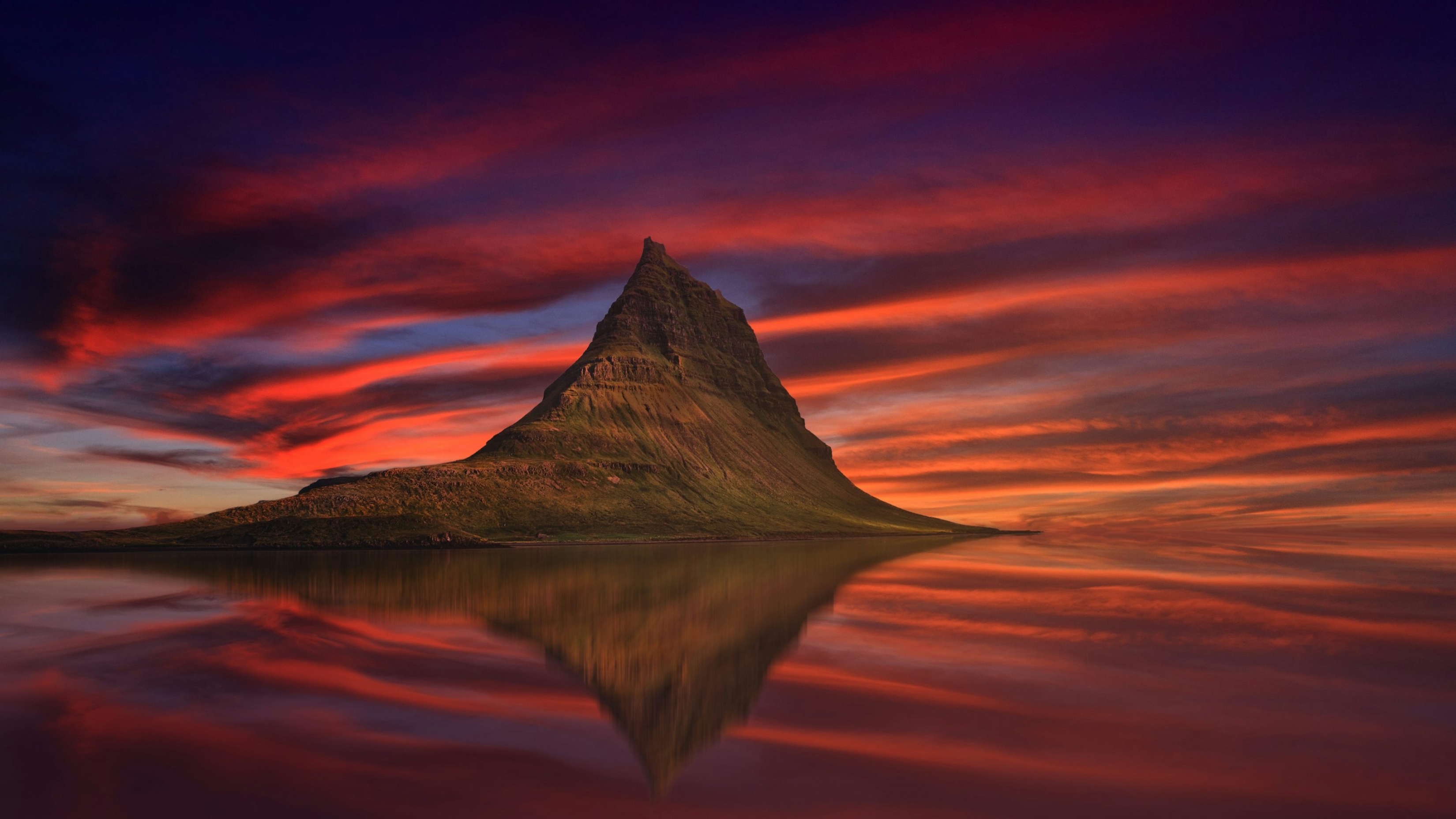 Vibrant Red Purple Sunset Over A Still Water Lake